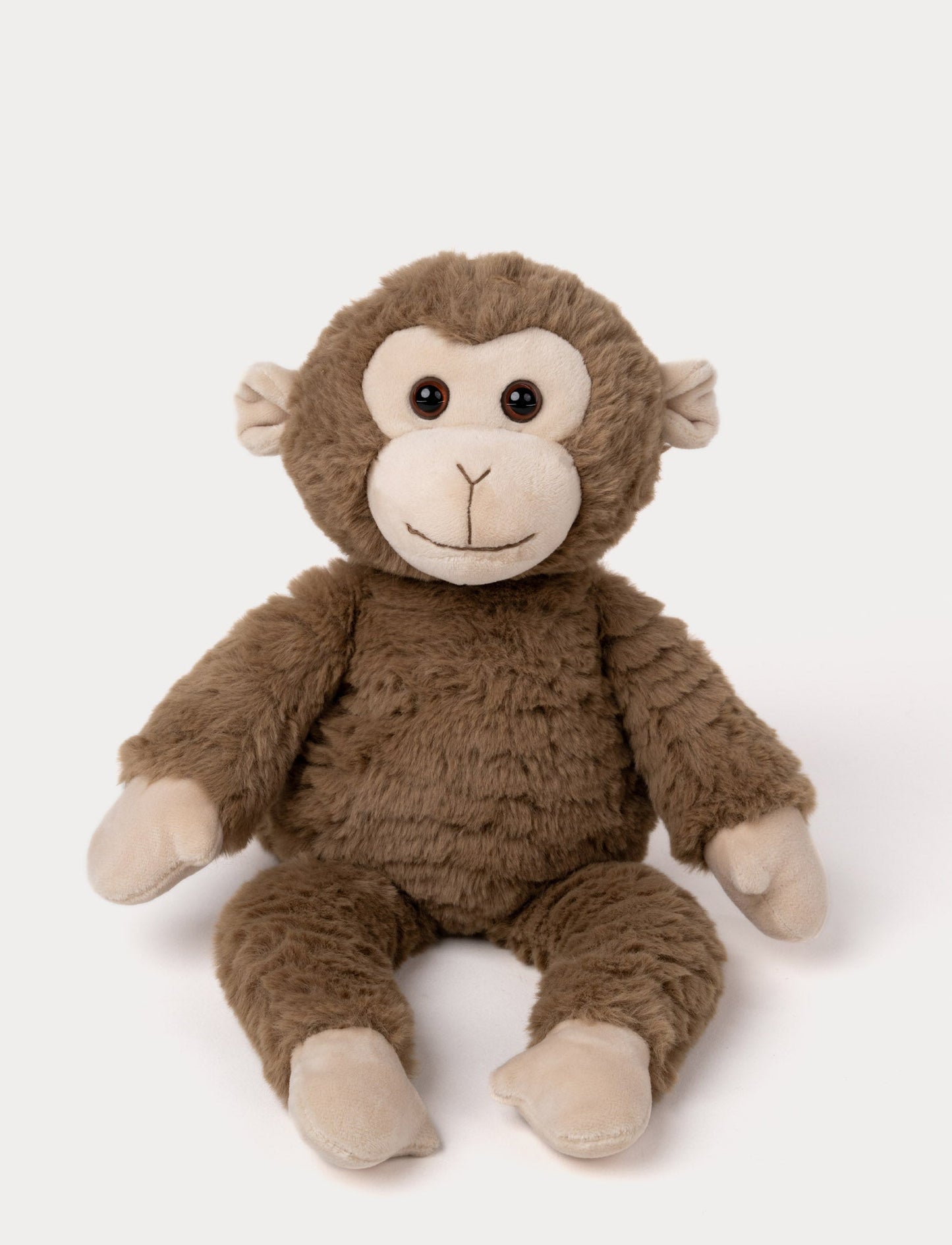 Soft plush monkey with brown fur, a beige face and paws, black bead eyes, and a stitched smile.