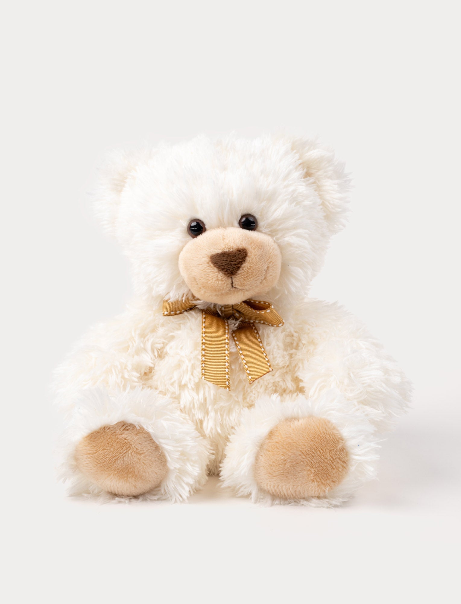 Image of A white teddy bear with soft fur, big eyes, and an elegant bow around his neck.