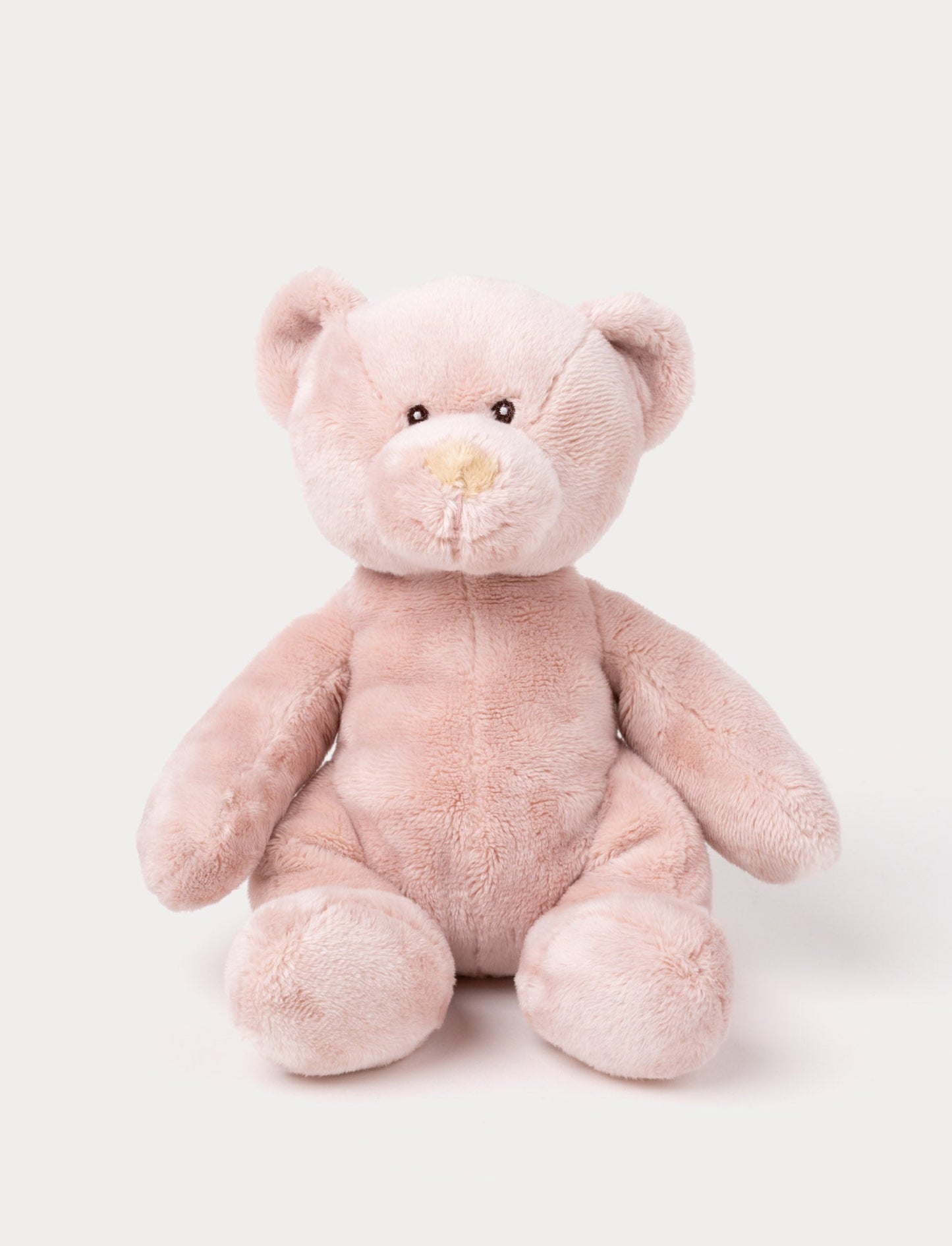 A small teddy bear with short, velvety pink fur and carefully stitched details.