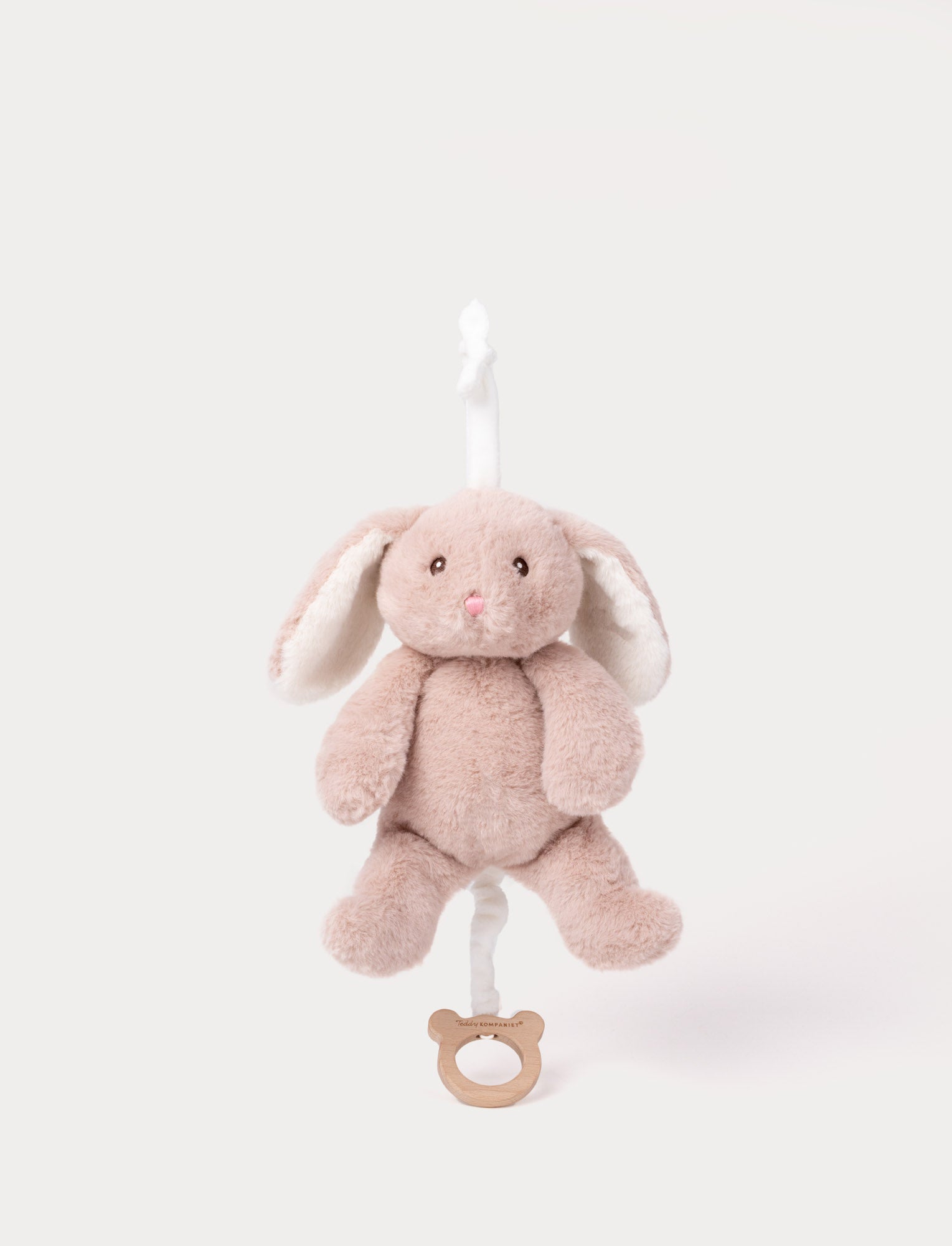  Image of Soft pink plush bunny music toy with floppy ears, black bead eyes, and a pull string for playing a lullaby.