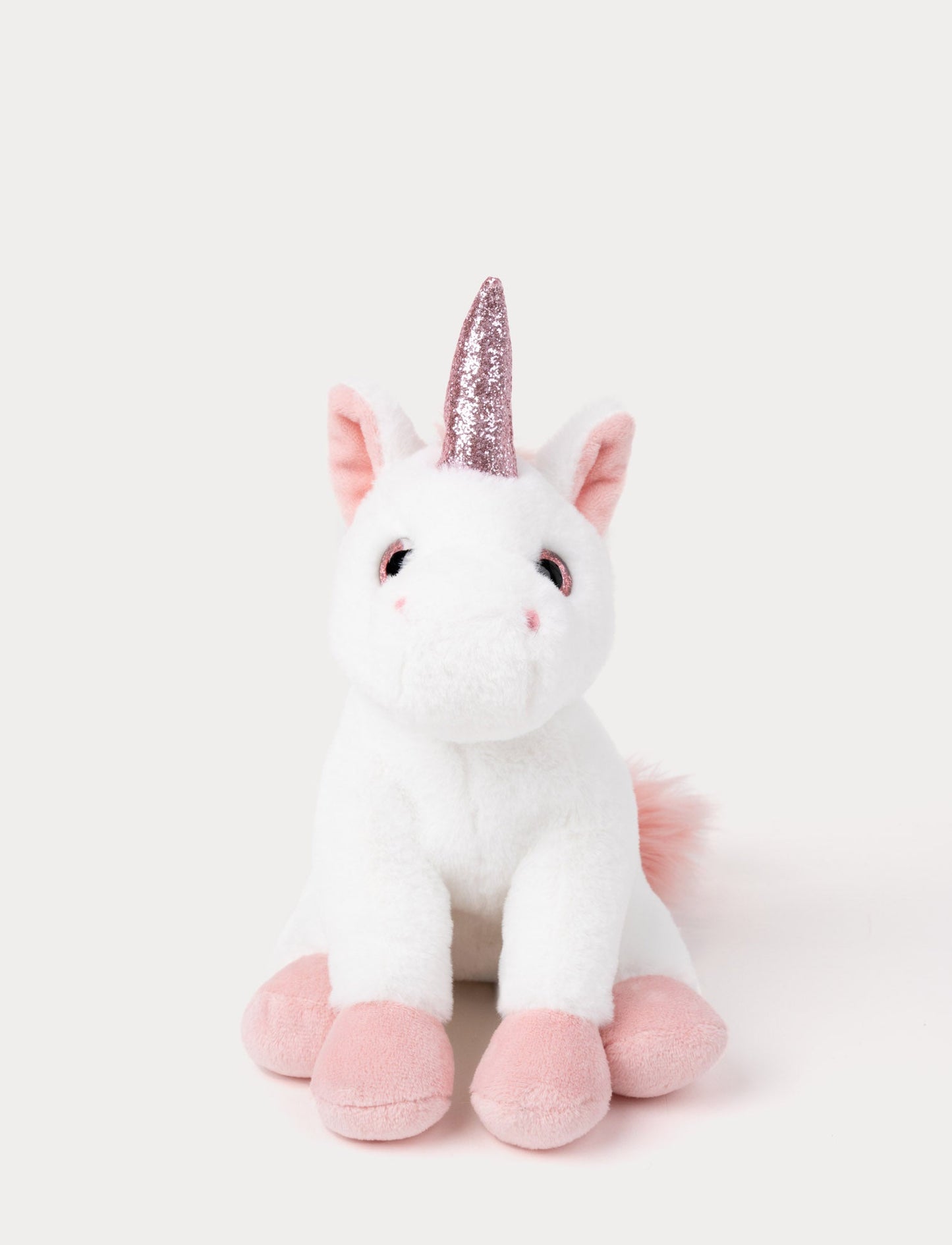 A white unicorn with velvety fur, soft pink details, a sparkling horn, and a fluffy mane and tail.