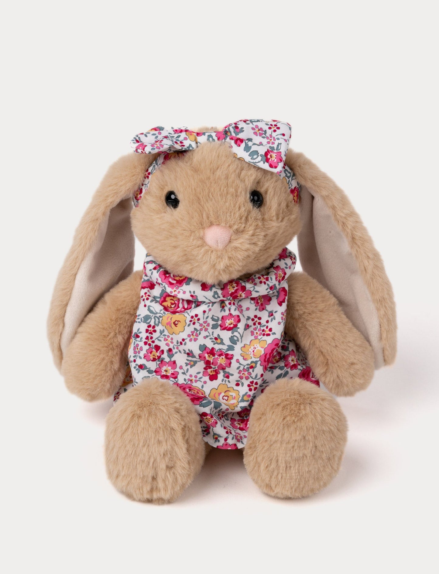 Soft plush bunny with long floppy ears, wearing a floral dress and matching bow.