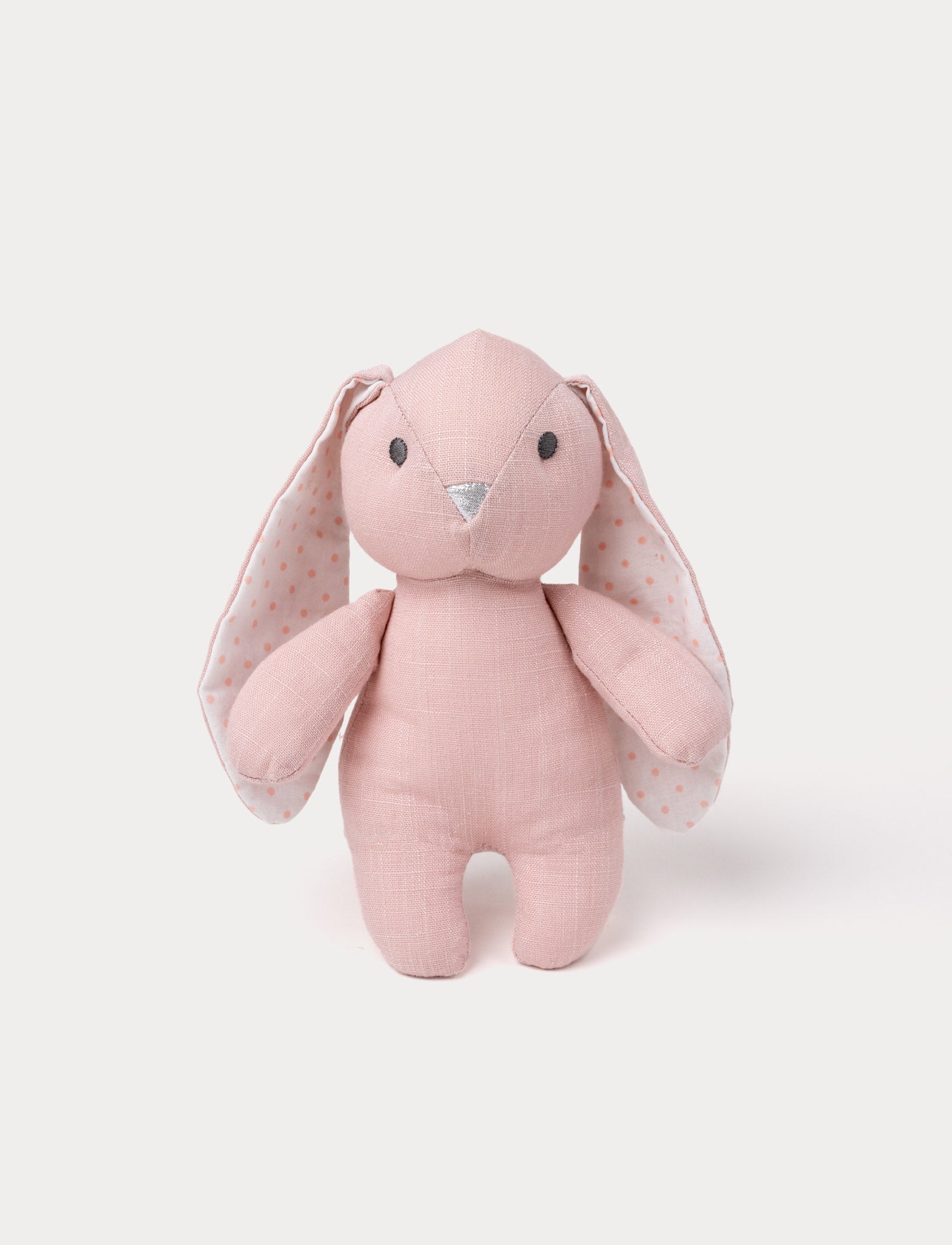  Image of A bunny with soft dusty pink fur, large white ears with pink polka dots, and a silver nose.