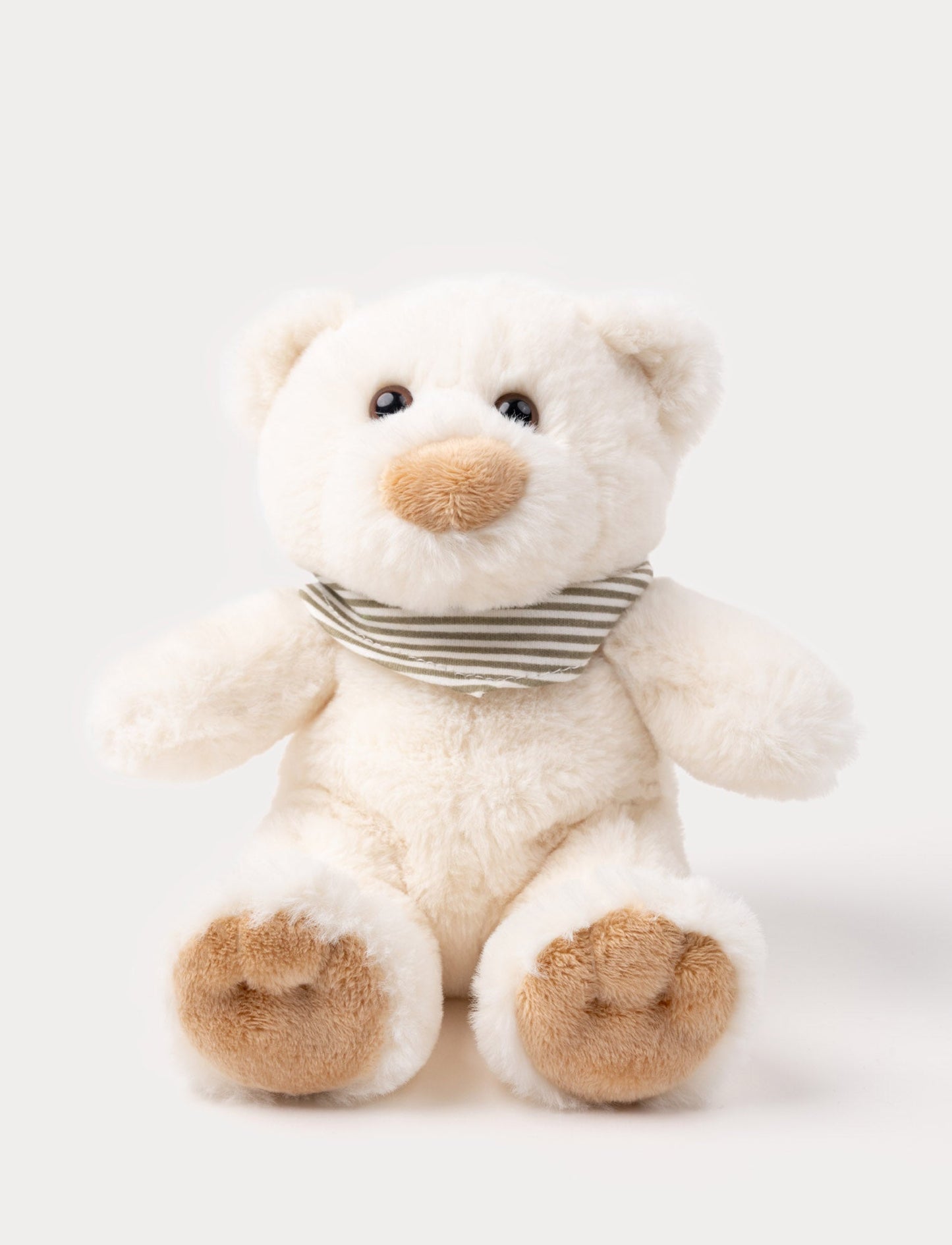 A teddy bear with cream-colored fur and a charming scarf, perfect for cuddling.
