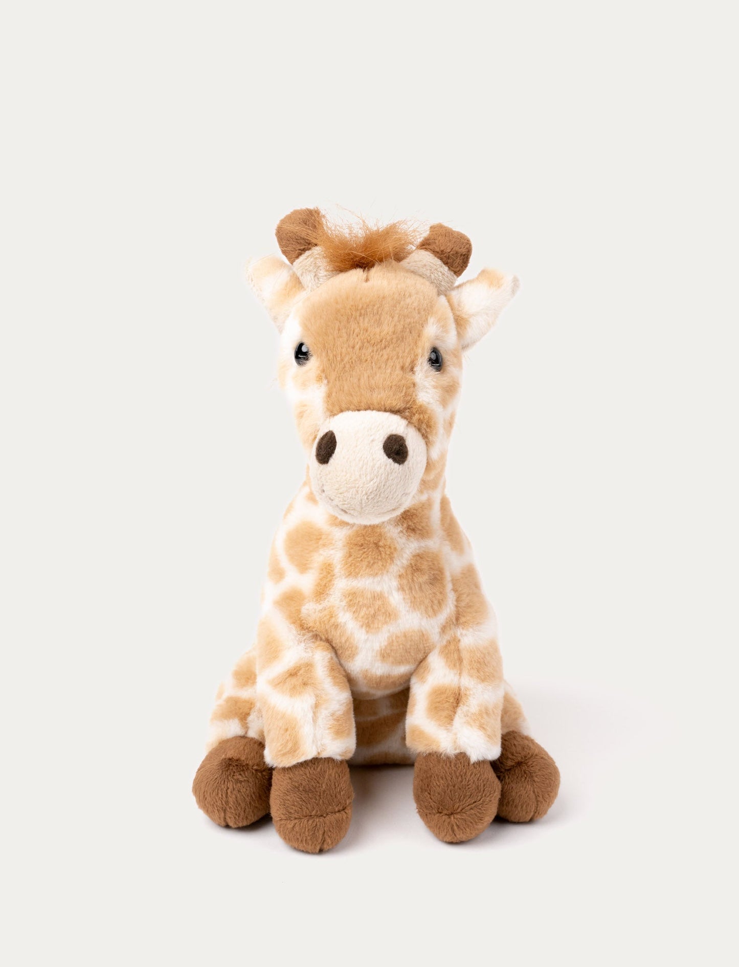 Soft plush giraffe with a light brown and cream spotted pattern, brown hooves, and a fluffy mane.