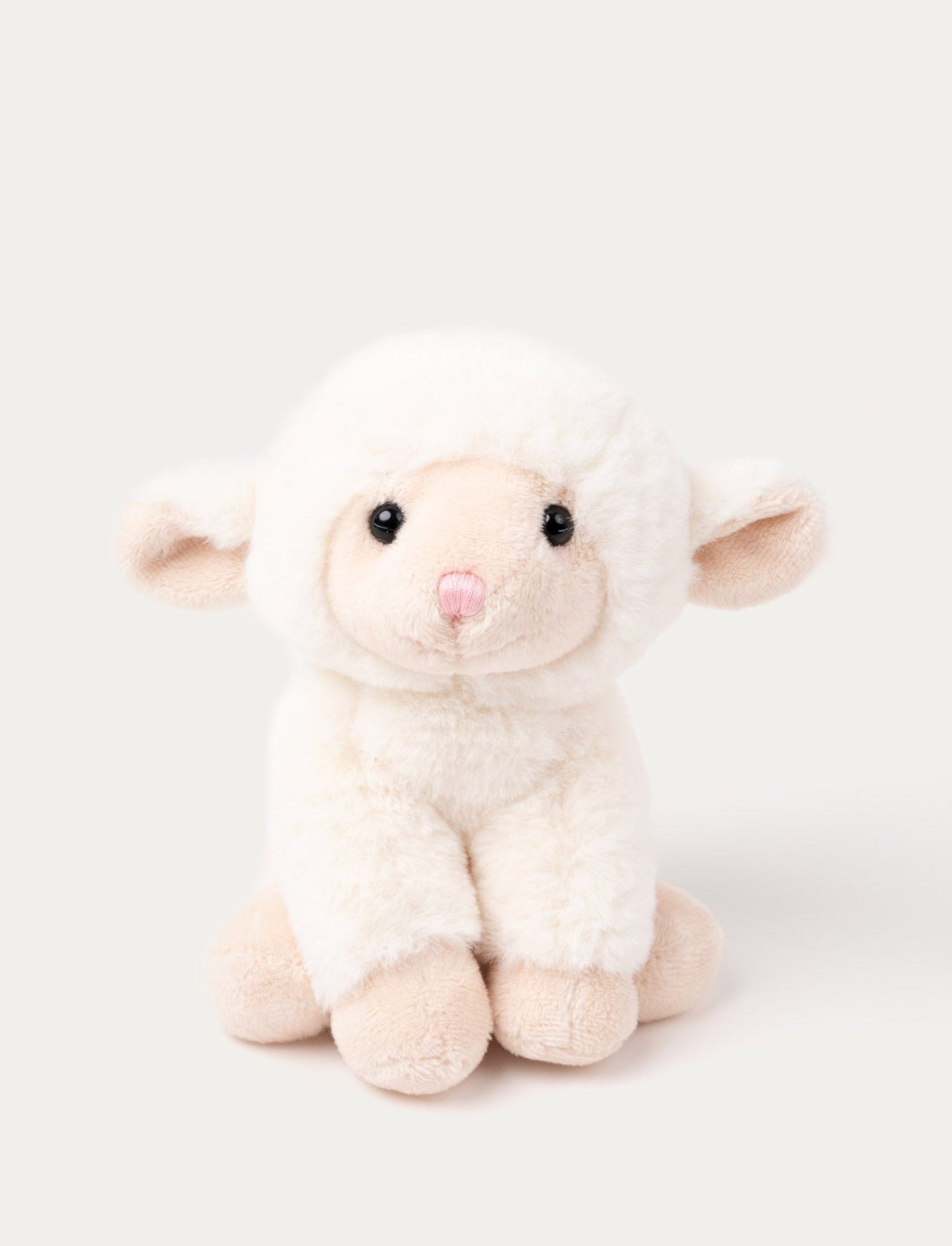 A small lamb with white soft fur and a cute expression, perfect for play and cuddles.
