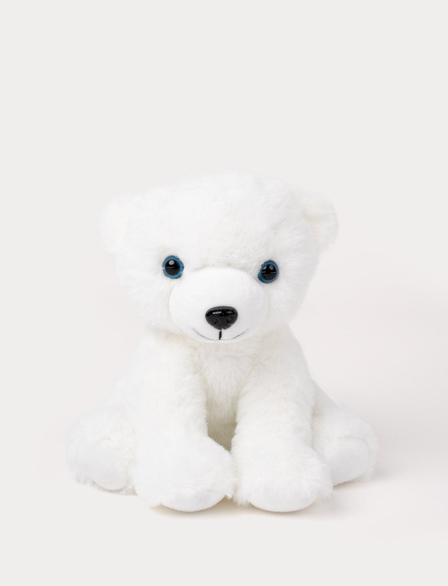 A polar bear with white fur and gentle blue eyes, perfect for cuddles and play.