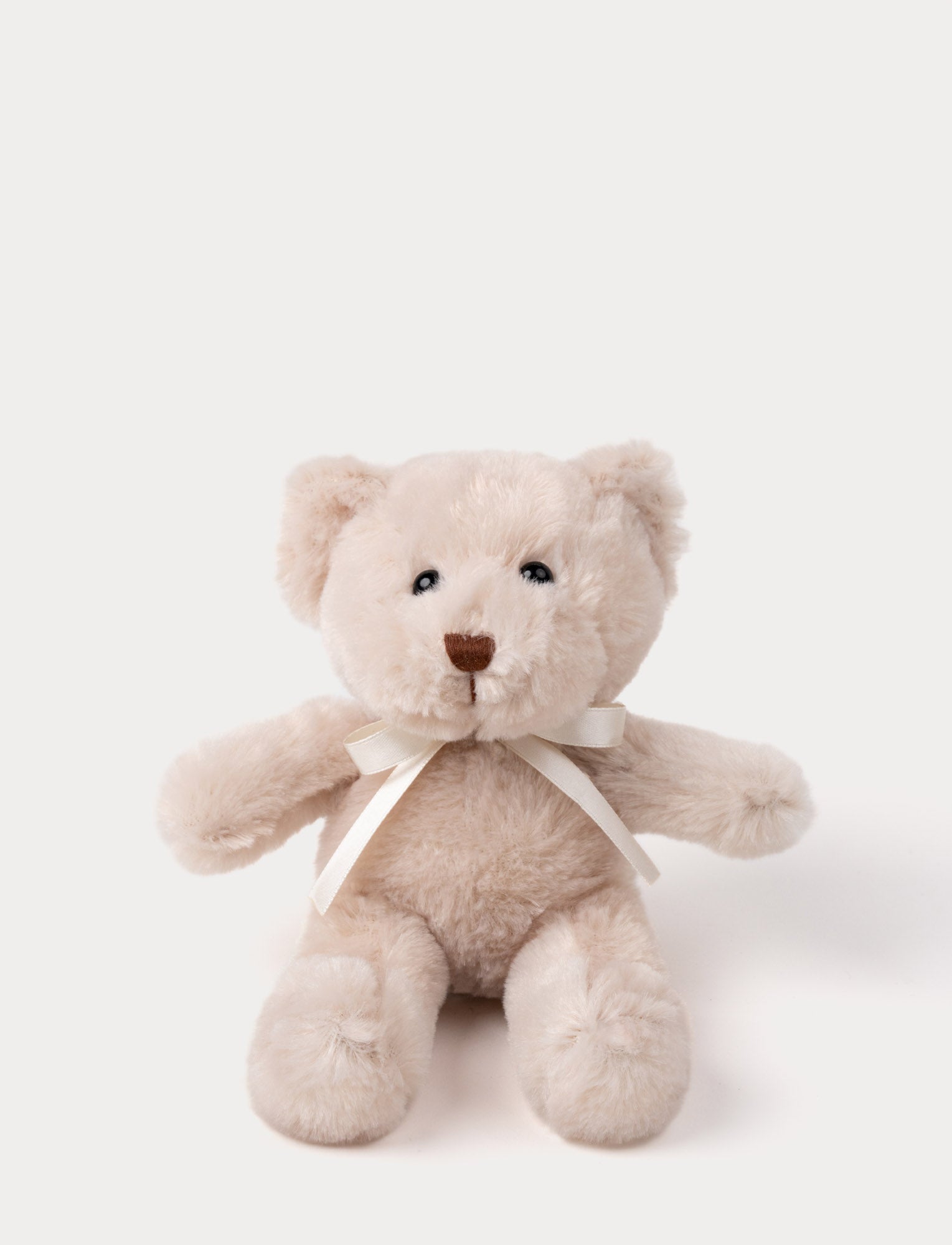  Image of A teddy bear with warm beige fur, an embroidered nose, and an adorable satin bow.
