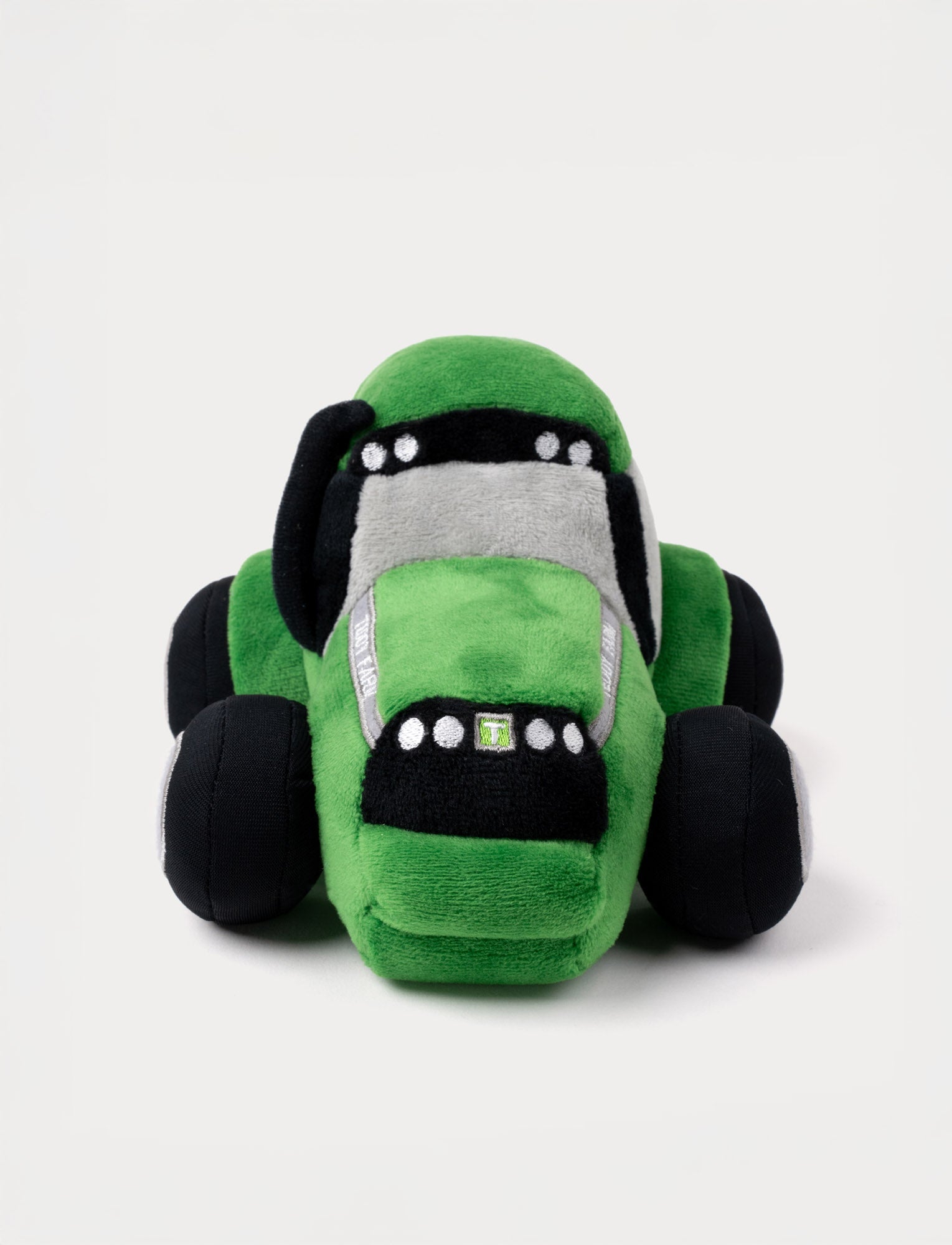  Image of A soft green tractor with plush construction, perfect for farm-themed play.