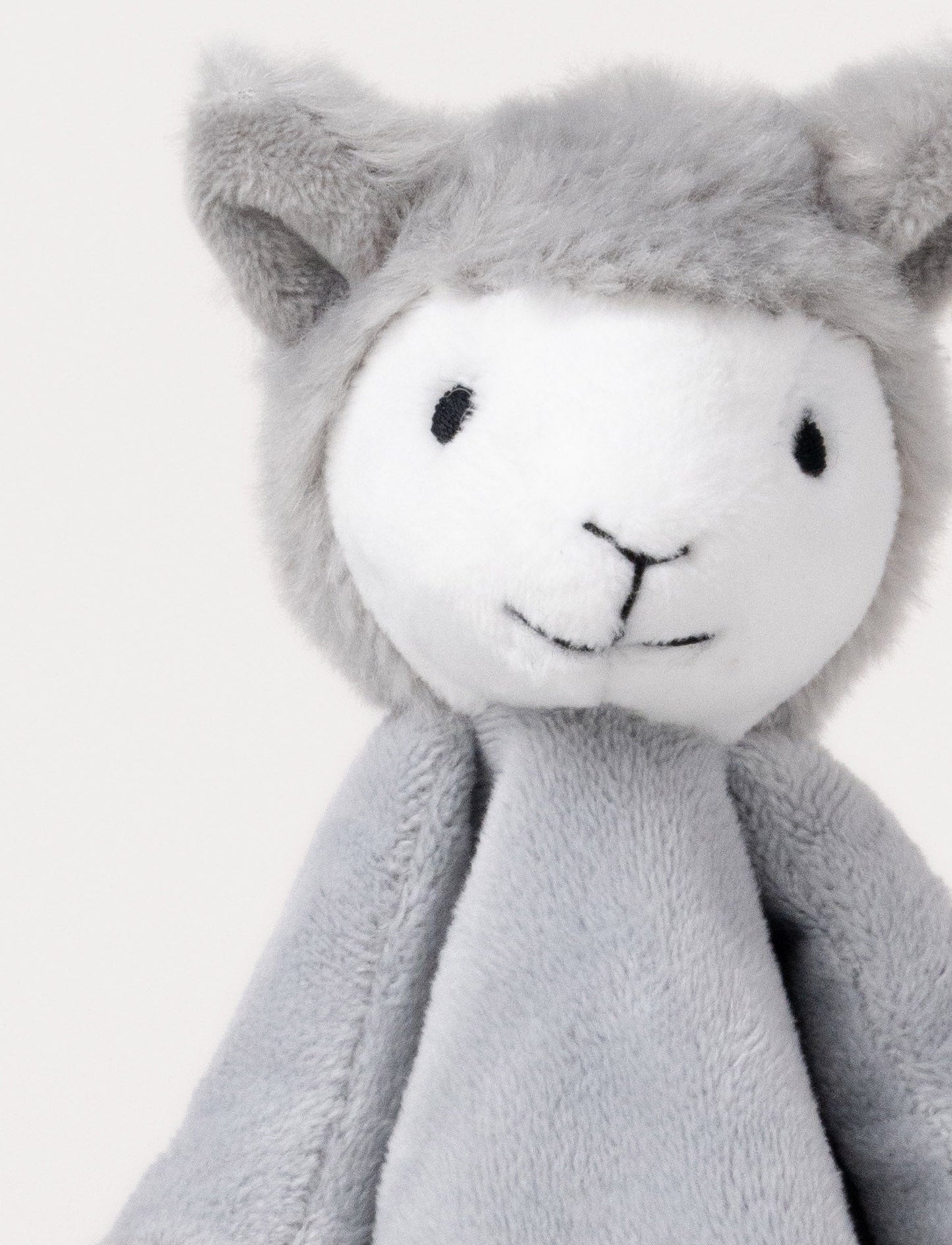 Soft baby blanket with a plush gray llama head, white face, and white-trimmed edges.
