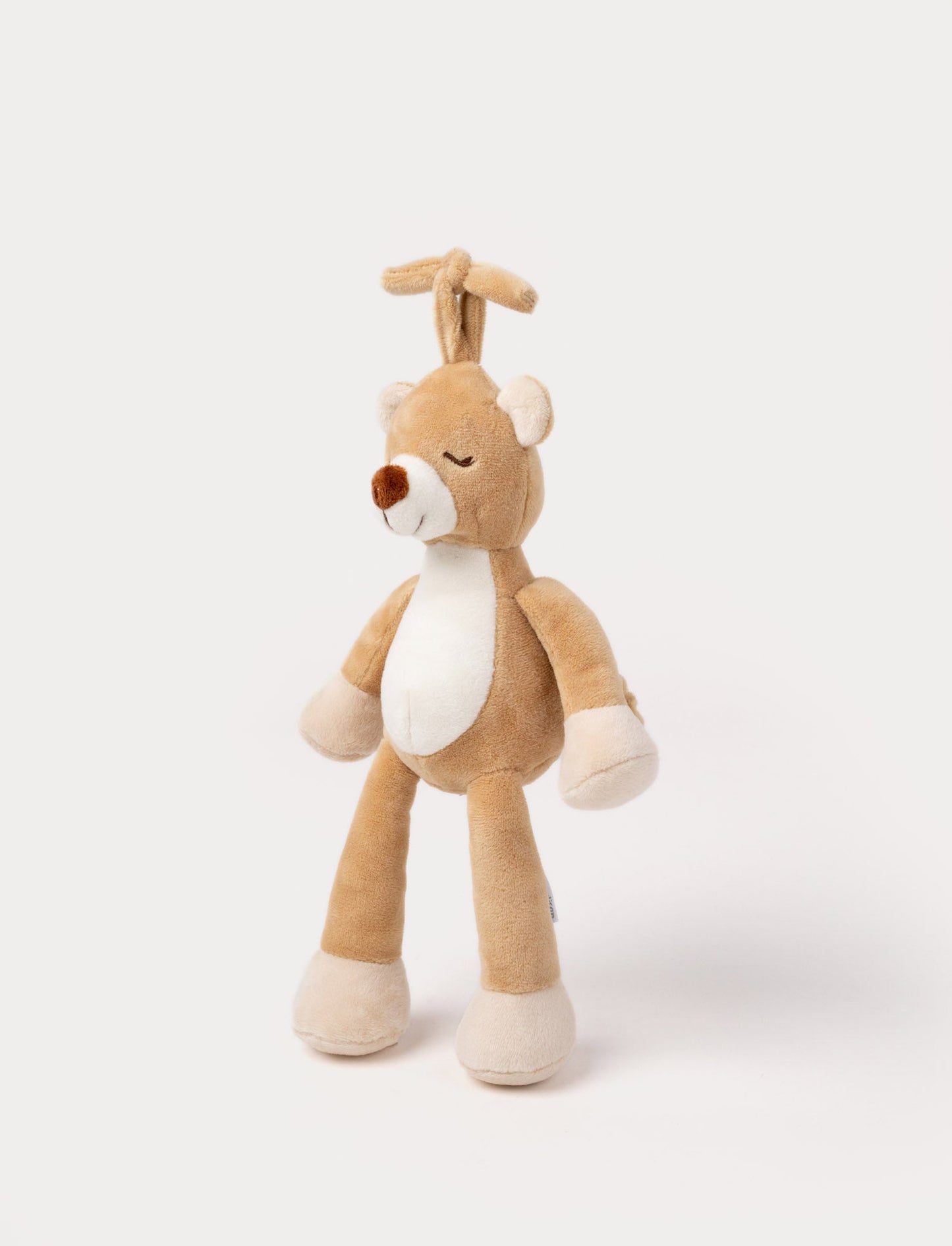 A plush brown teddy bear music box with a white belly, closed eyes, and a hanging loop.