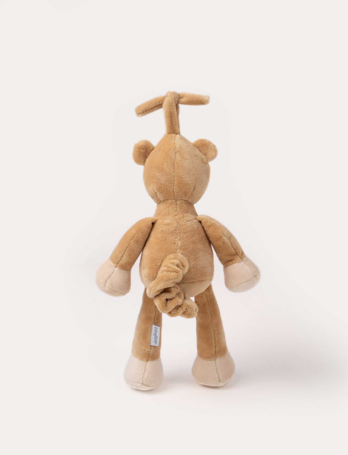 A plush brown teddy bear music box with a white belly, closed eyes, and a hanging loop.