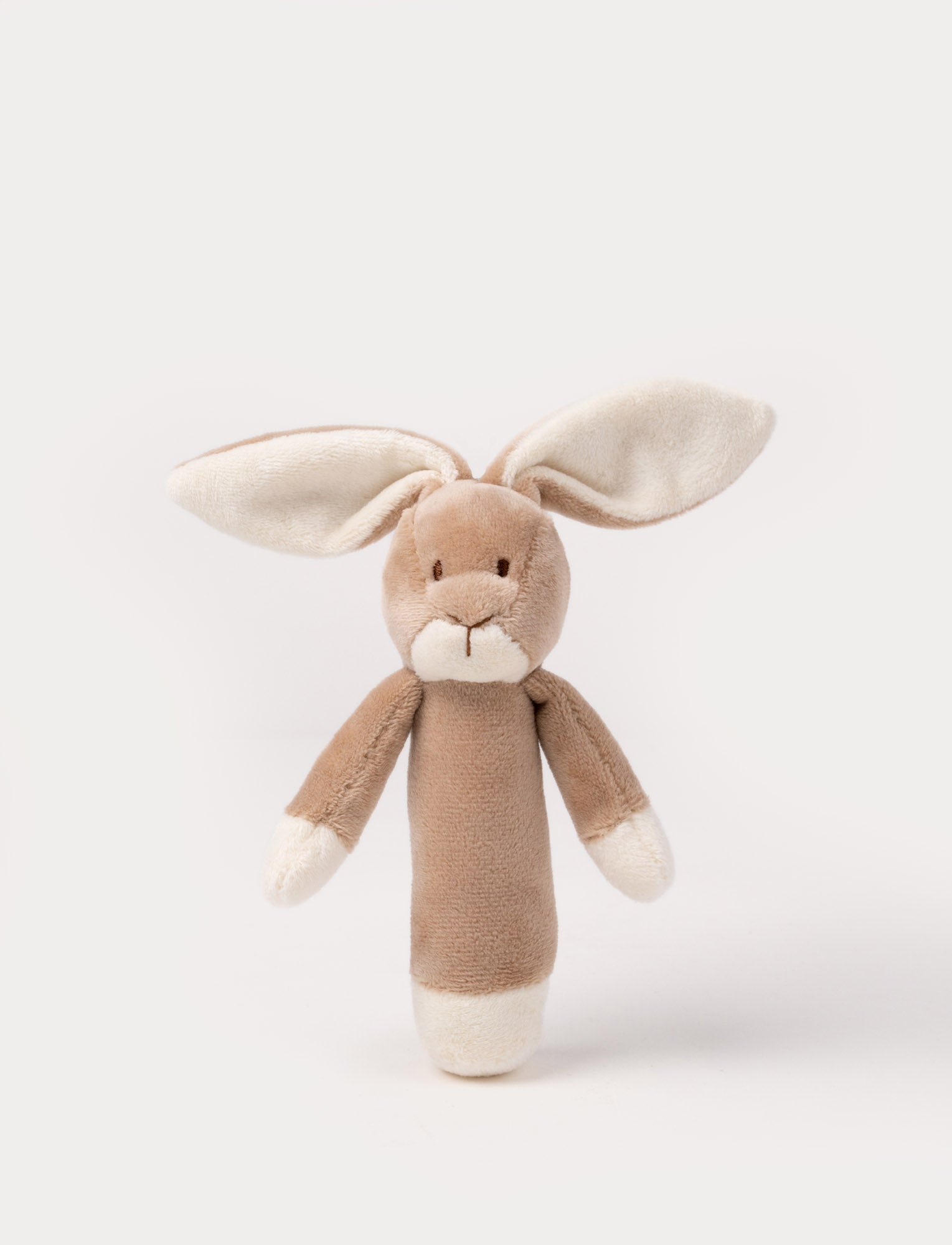  Image of Soft plush bunny rattle with a light brown body, long floppy ears, embroidered eyes, and white accents on the hands and base.