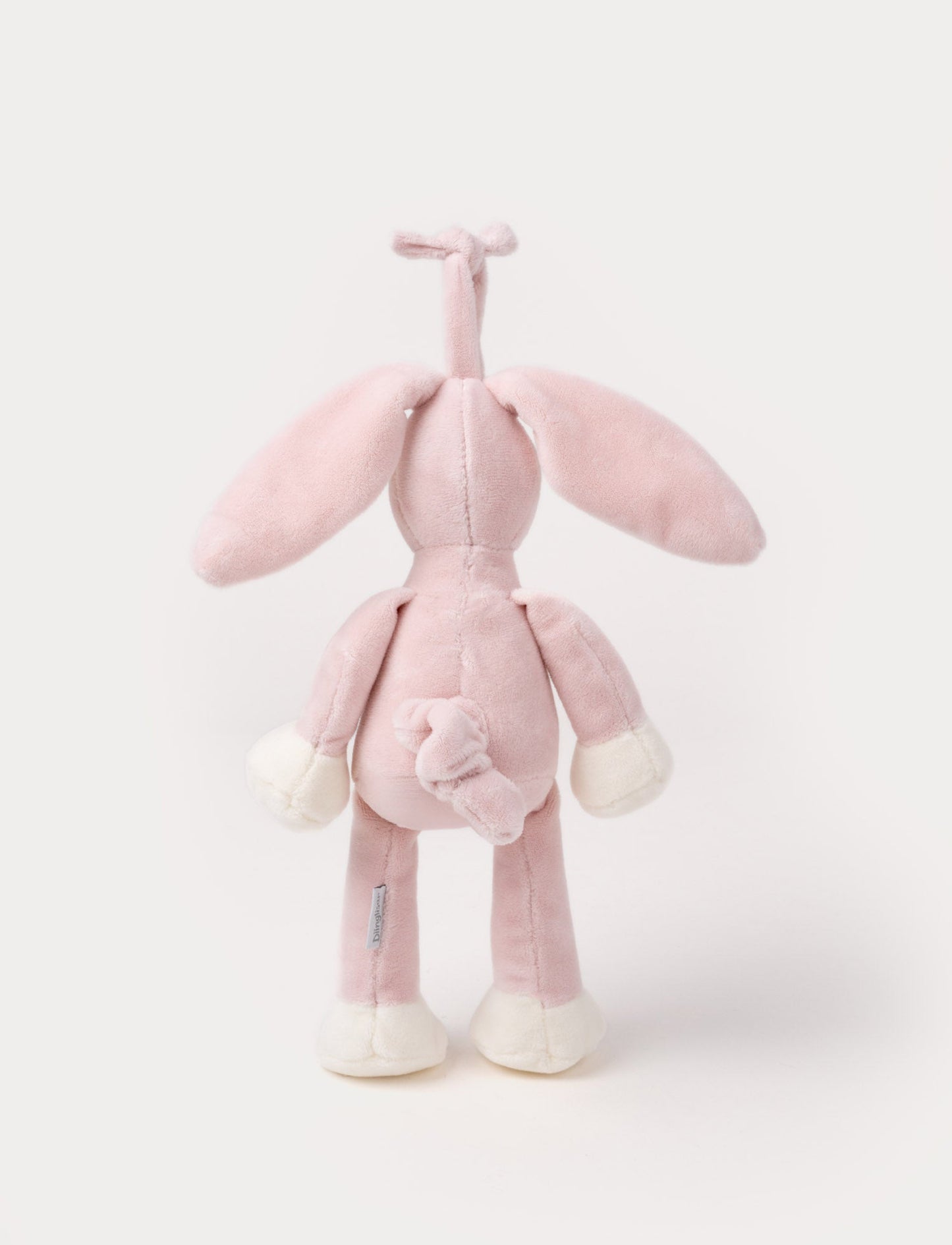 A plush dusty pink bunny music box with long floppy ears, a white belly, and a hanging loop