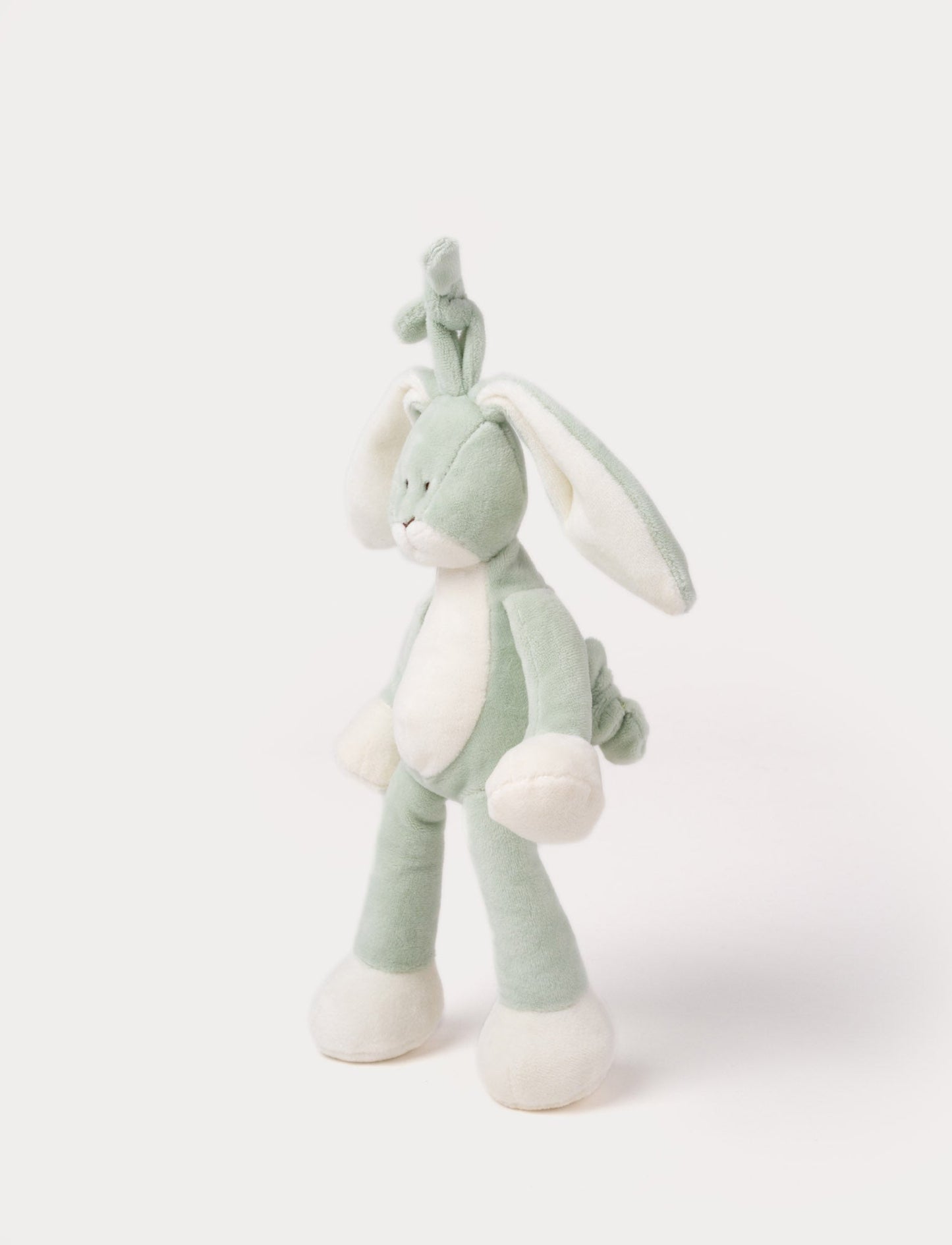 A plush sage green bunny music box with long floppy ears, a white belly, and a hanging loop.