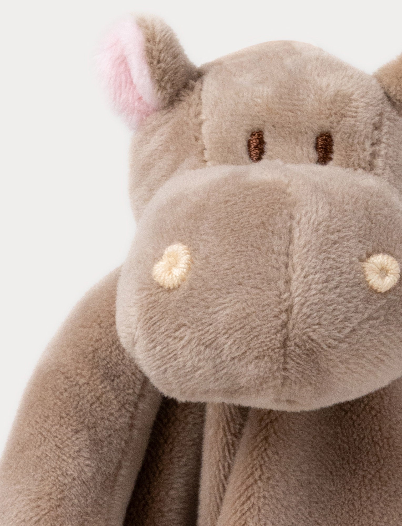  Image of Soft baby blanket with a plush brown hippo head, small pink ears, and white-trimmed edges.