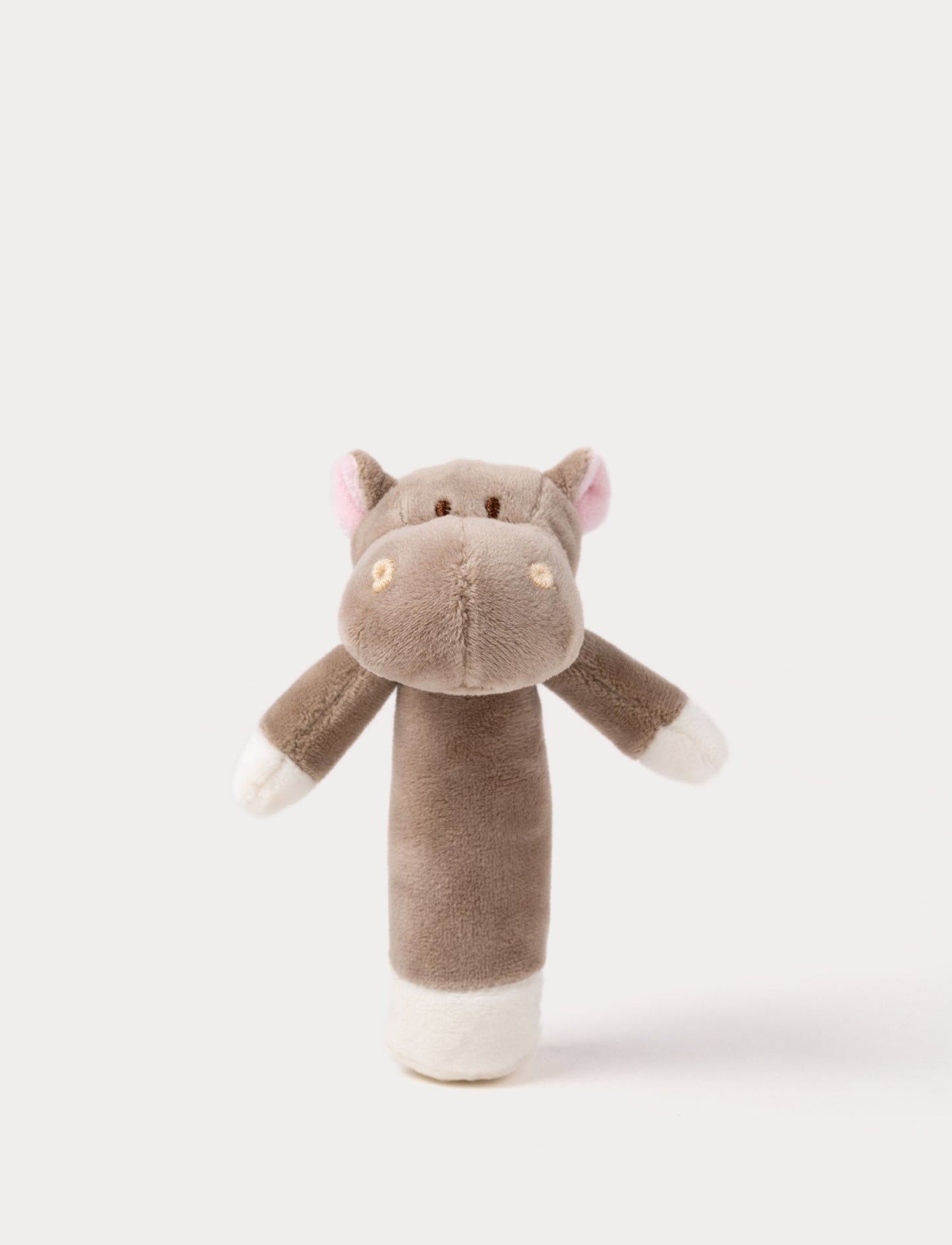 Soft plush hippo rattle with a brown body, embroidered eyes, small pink ears, and white accents on the hands and base.