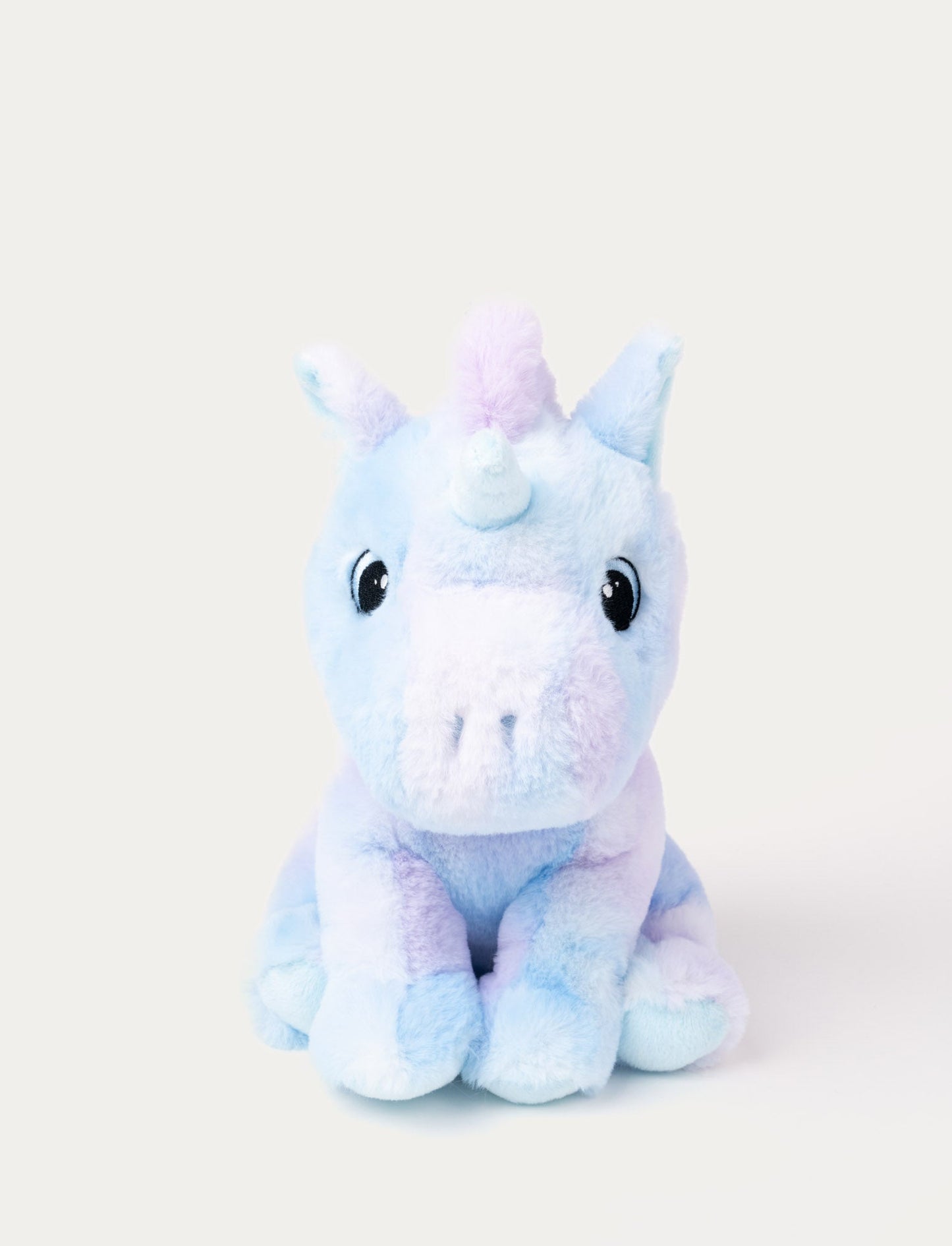A pastel purple and blue unicorn with soft fur and embroidered eyes.