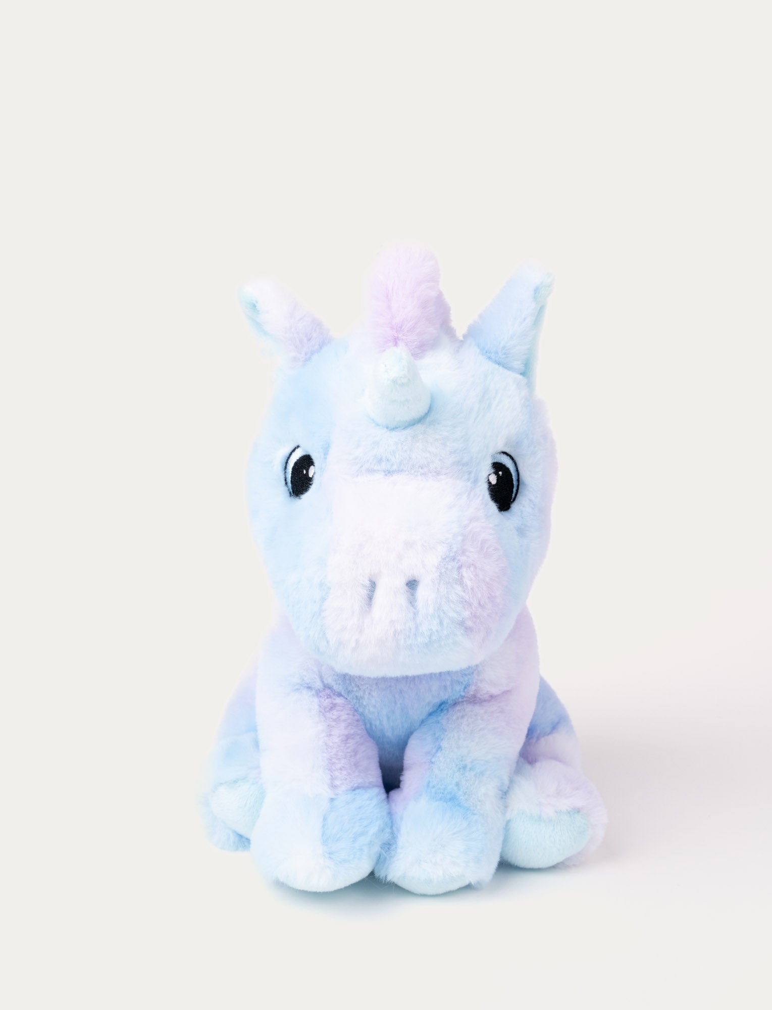  Image of A pastel purple and blue unicorn with soft fur and embroidered eyes.