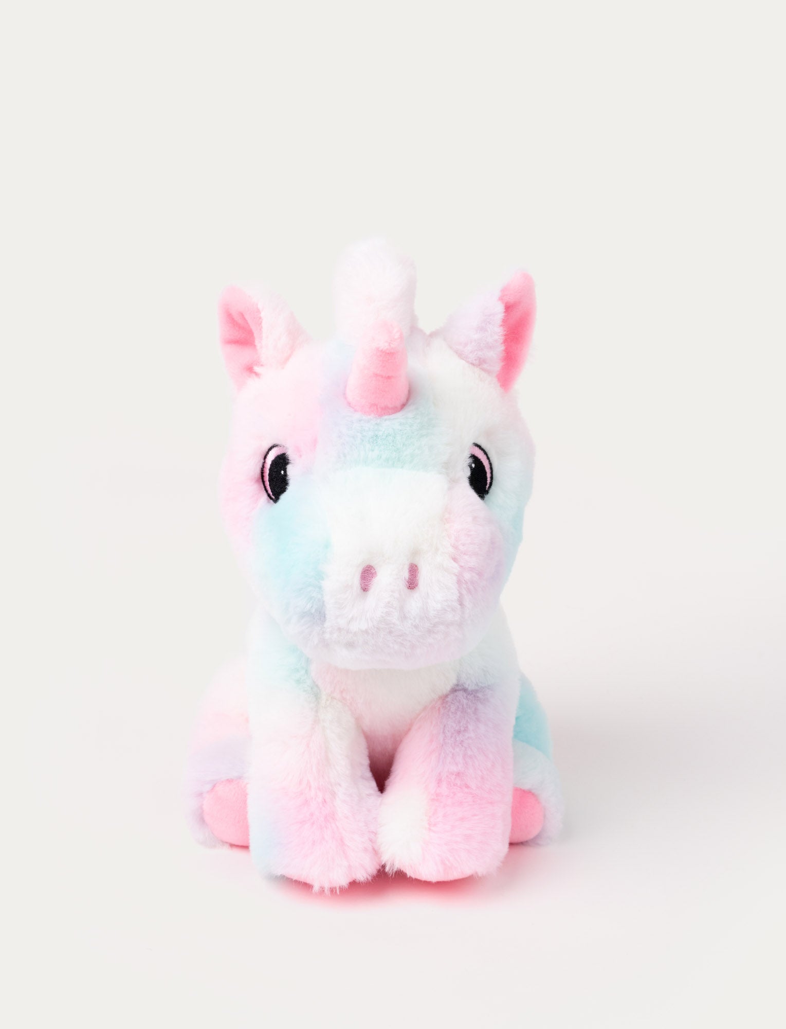  Image of A pastel pink and blue unicorn with soft fur and embroidered eyes.