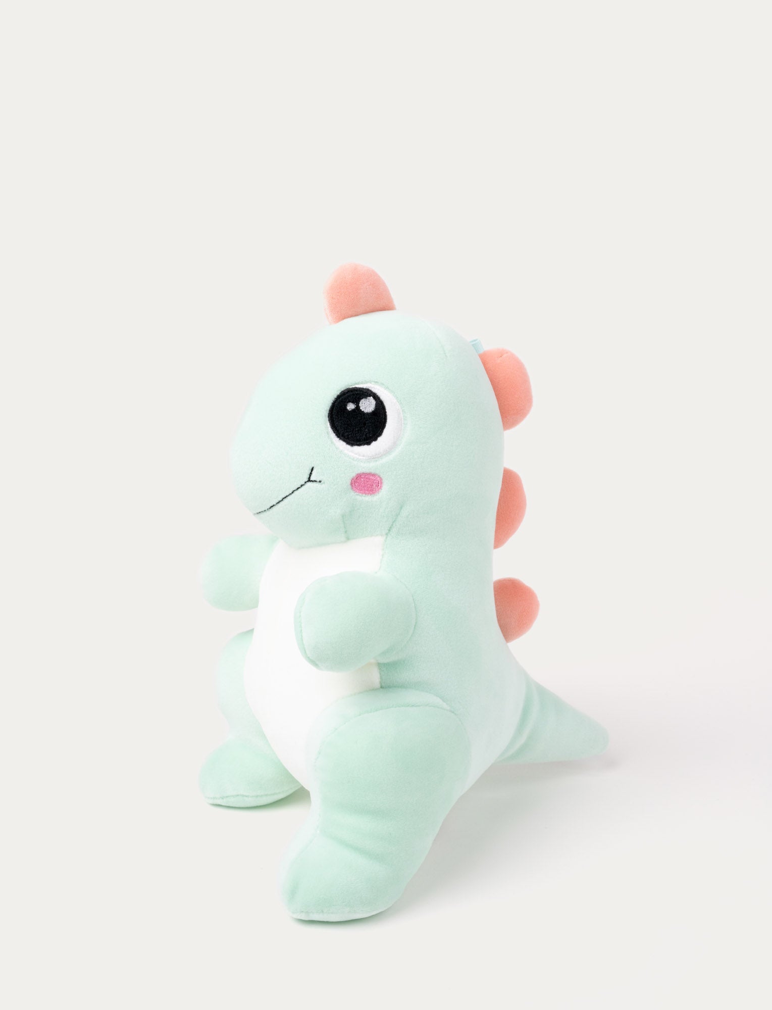  Image of soft dinosaur in mint color with squishy filling, smooth spandex fabric, and embroidered details.