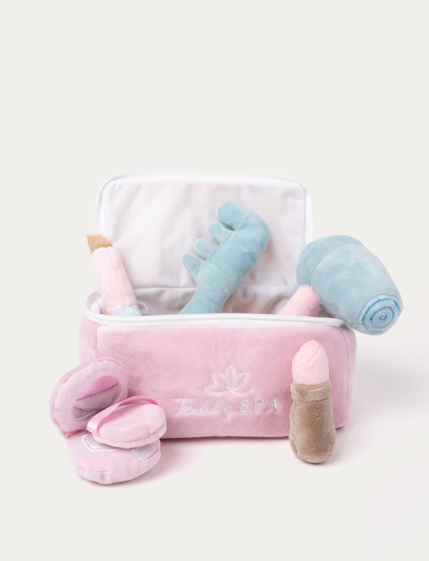 A soft plush spa set with a comb, hairdryer,t, makeup brush, lipstick in a  carry case. Pink & blue
