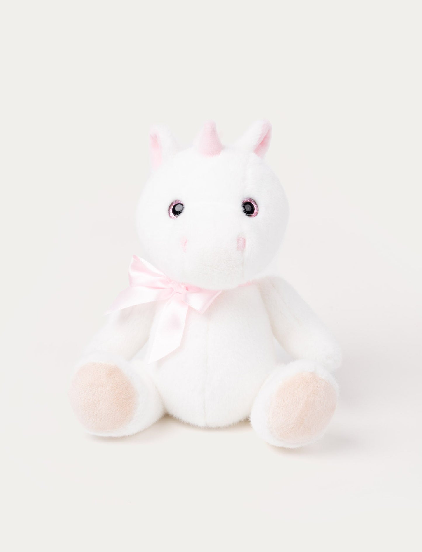 A white unicorn with a satin bow, sparkling eyes, fluffy ears, and silky, cashmere-like fur.