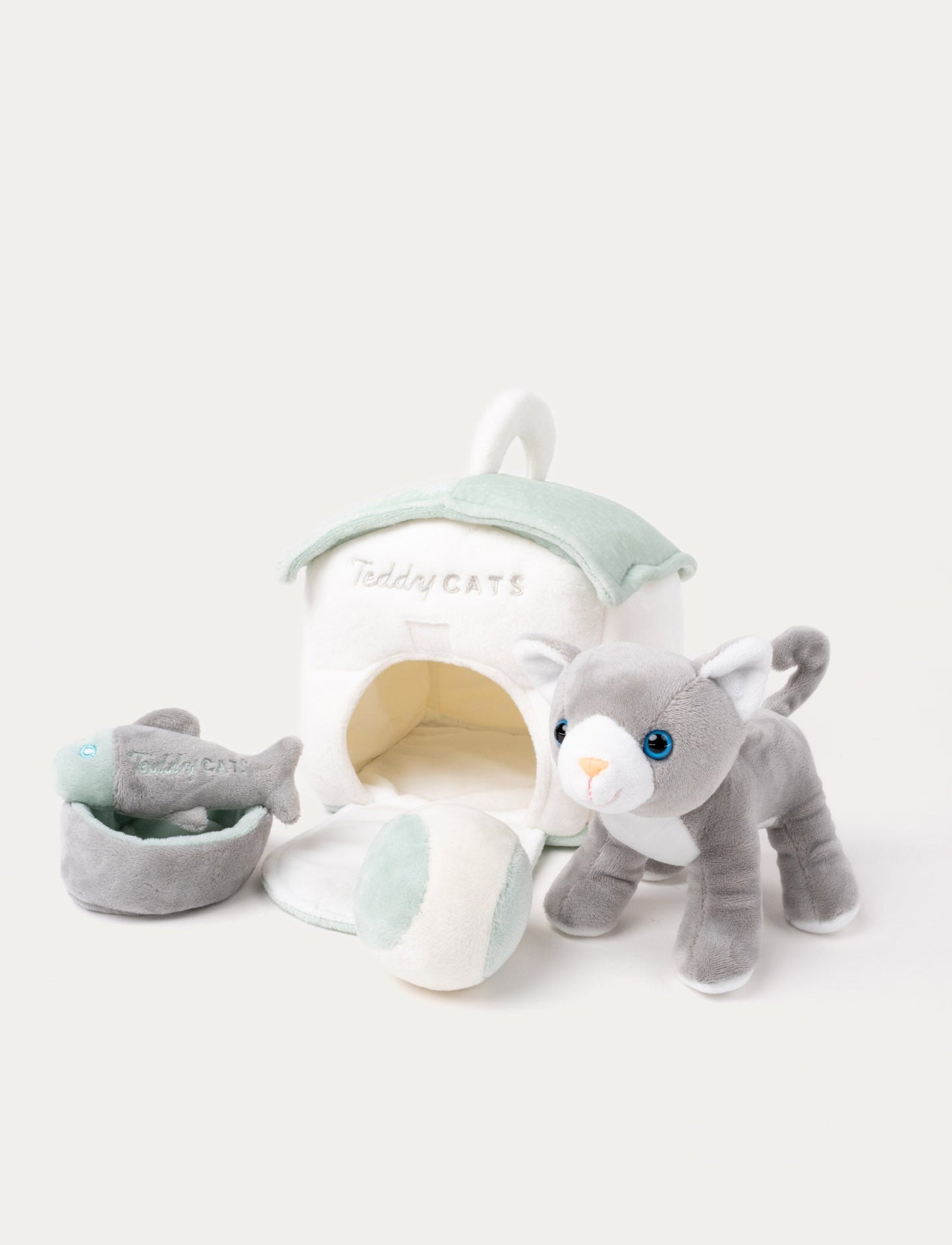 A plush kitten with a cat house, fishbone toy, water bowl, and ball, perfect for imaginative play.