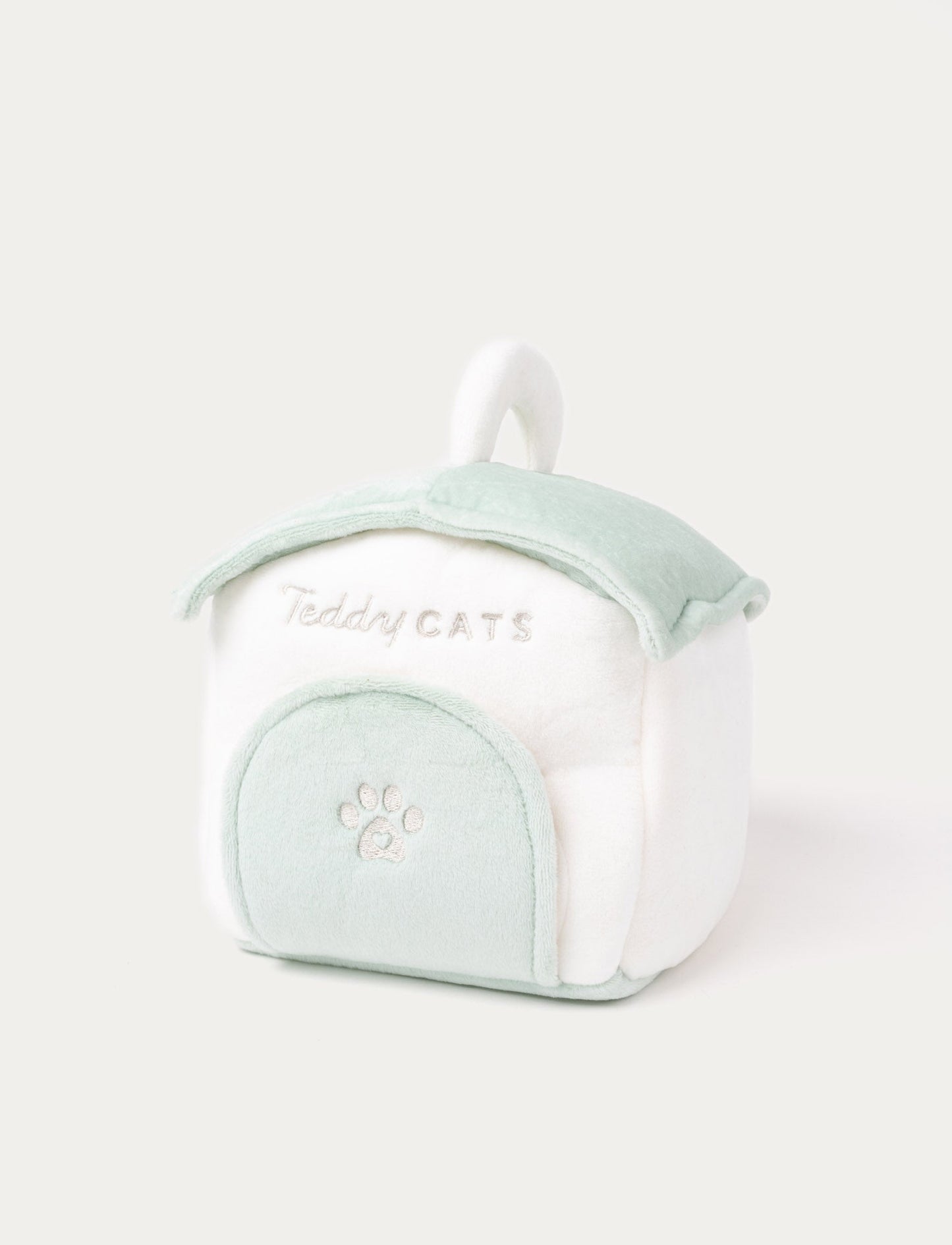 A plush kitten with a cat house, fishbone toy, water bowl, and ball, perfect for imaginative play.