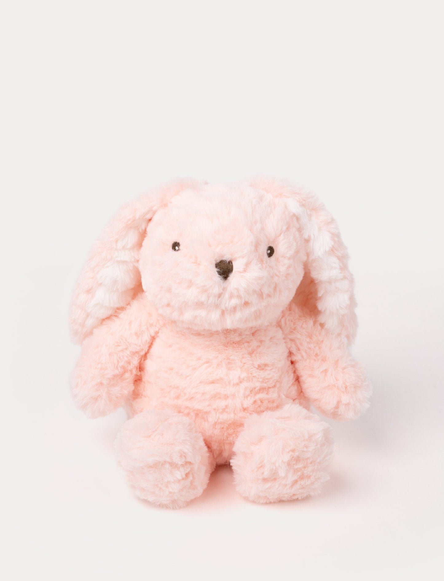 Soft pink bunny plush with floppy ears, fluffy fur, and a stitched nose.