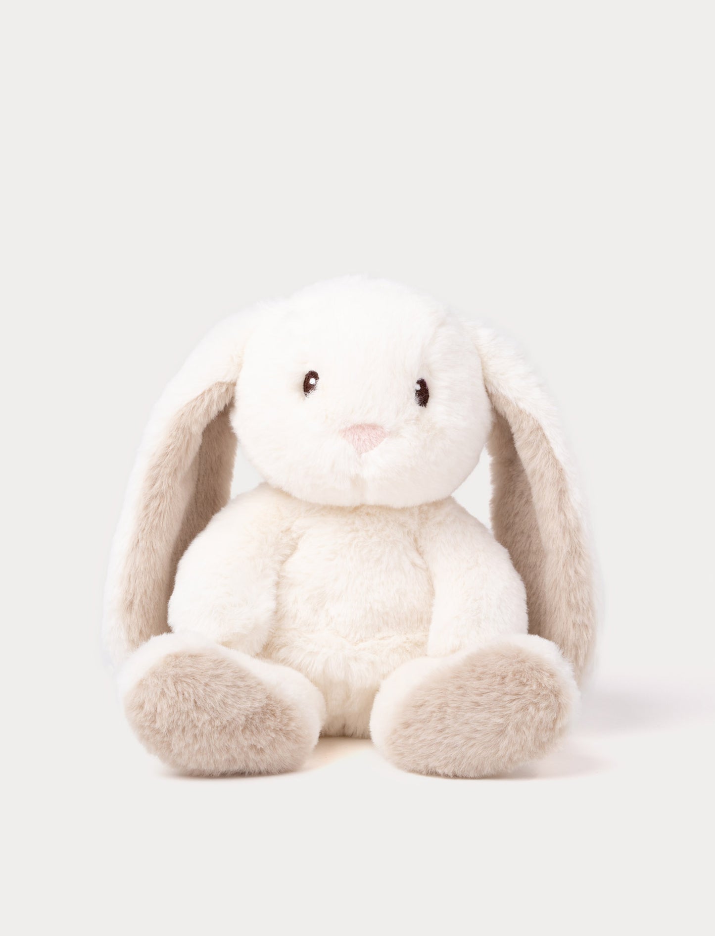 A cream plush bunny with silky-soft fur, faux suede detail on its back, and embroidered eyes.