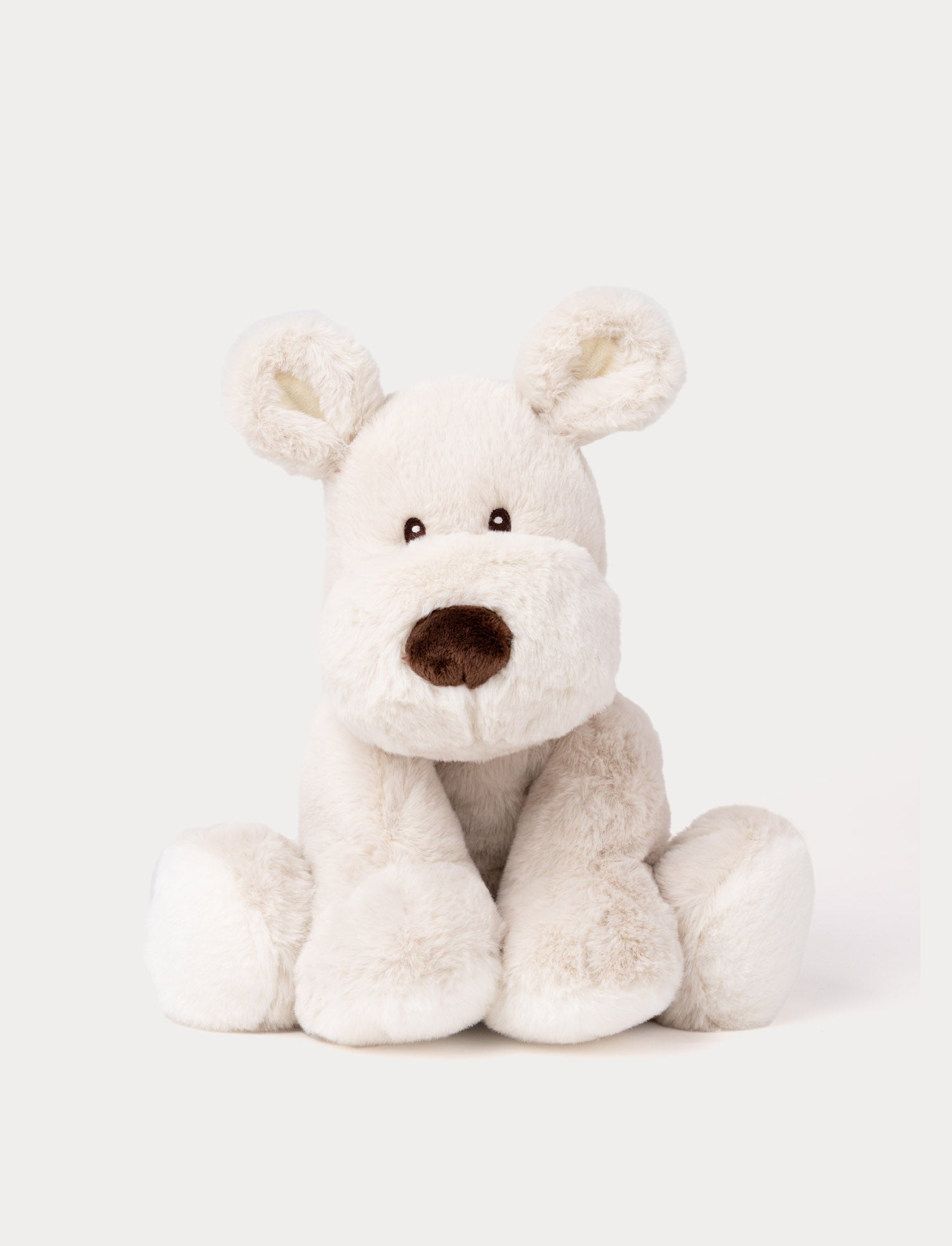  Image of A beige plush dog with soft fur, faux suede detail on its back, and embroidered eyes.