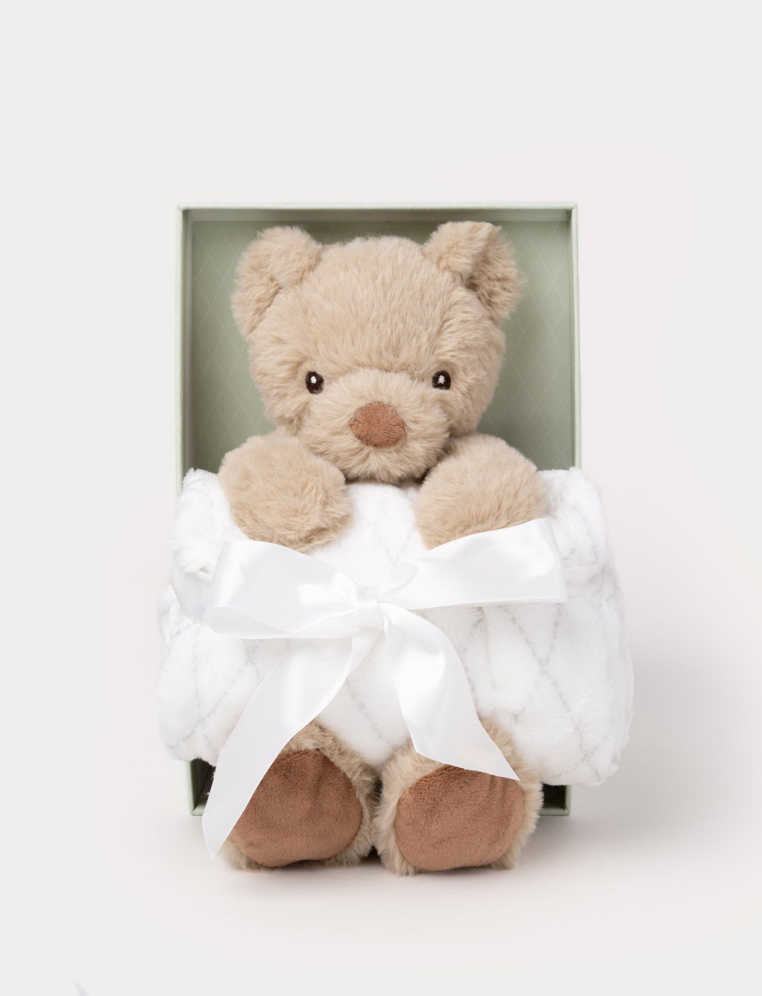  Image of Gift set with a beige plush teddy bear holding a soft white blanket tied with a satin ribbon, presented in a green box.