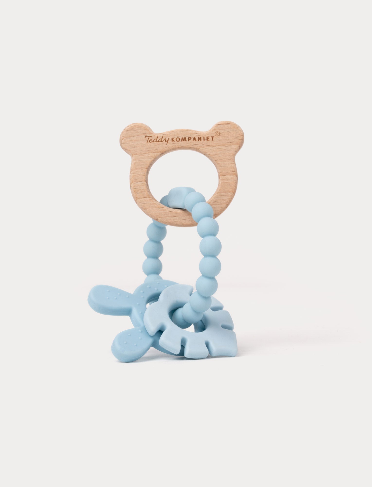  Image of Wooden and silicone baby teething toy in blue with a bear-shaped handle, beaded loop, and soft textured shapes.