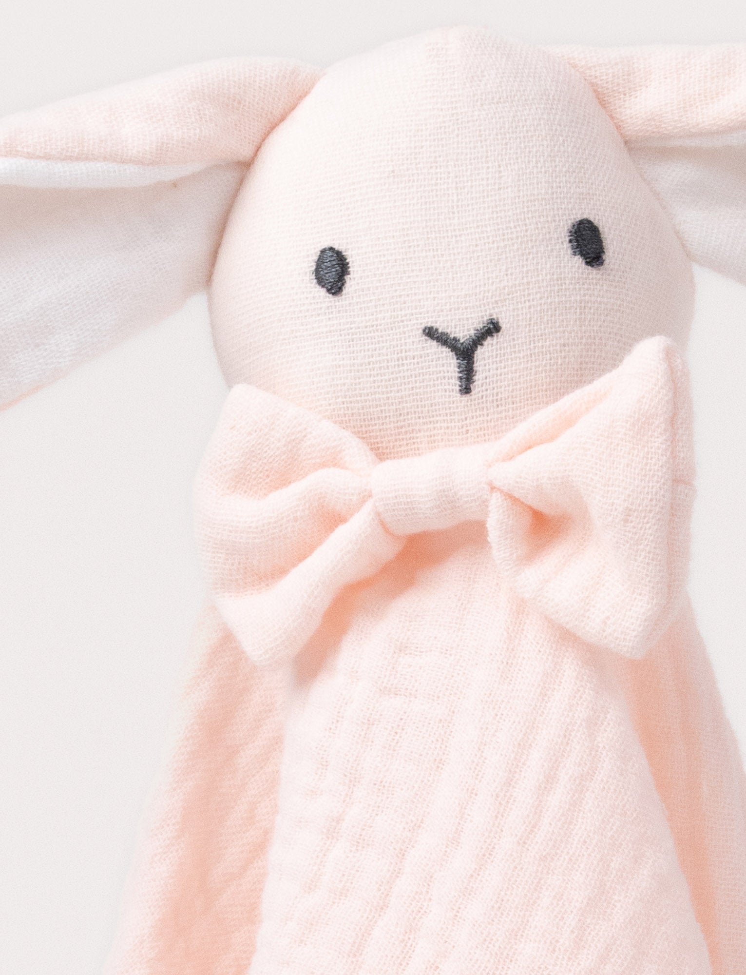  Image of Soft baby blanket with a plush pink bunny head, long floppy ears, and a small bow.