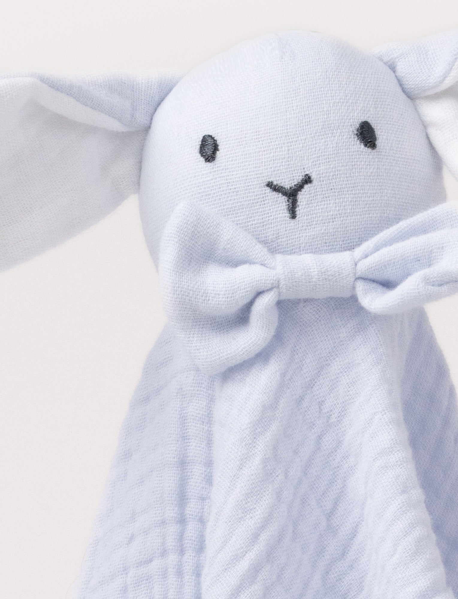  Image of Soft baby blanket with a plush light blue , levander, bunny head, long floppy ears, and a small bow.