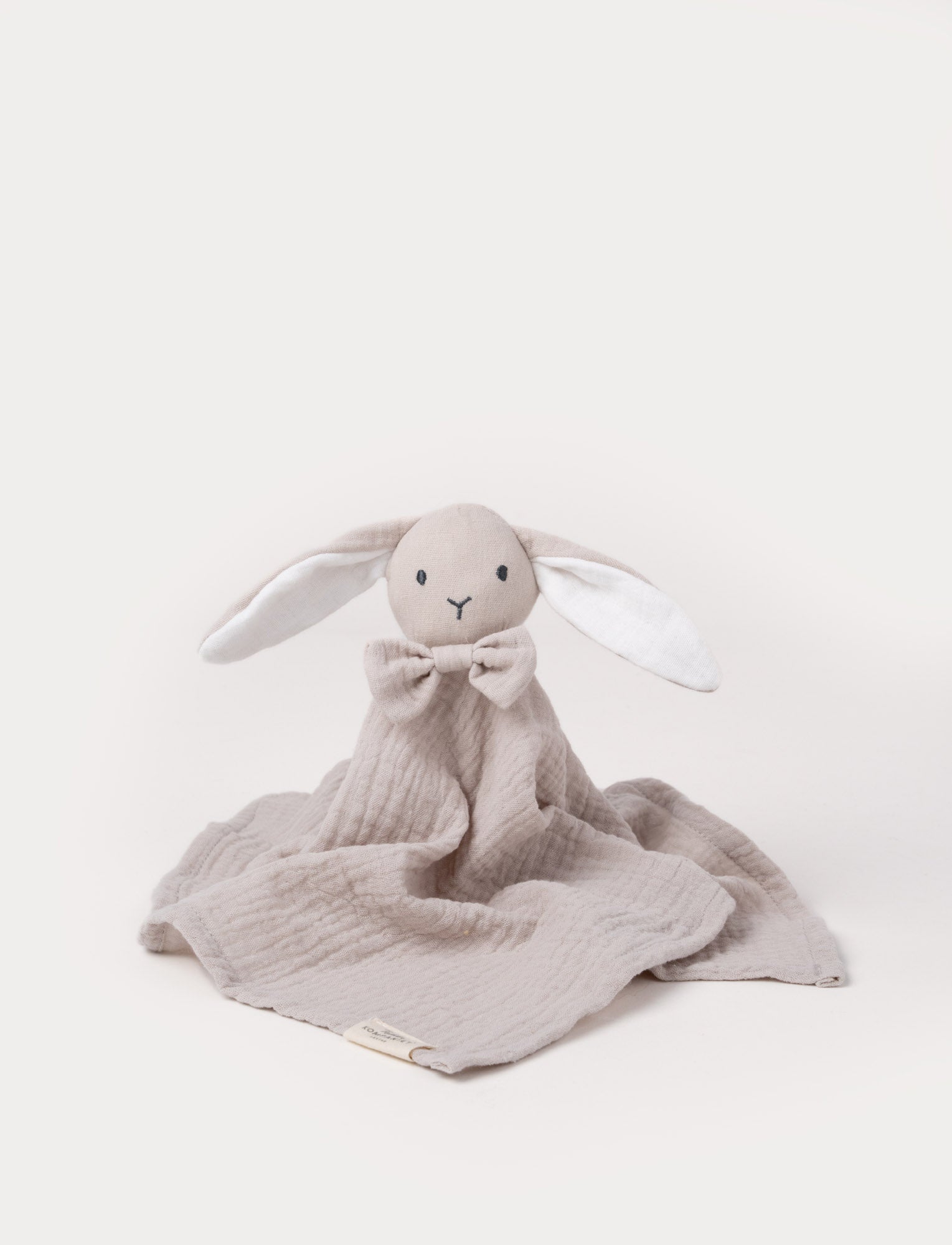  Image of Soft baby blanket with a plush beige bunny head, long floppy ears, and a small bow.
