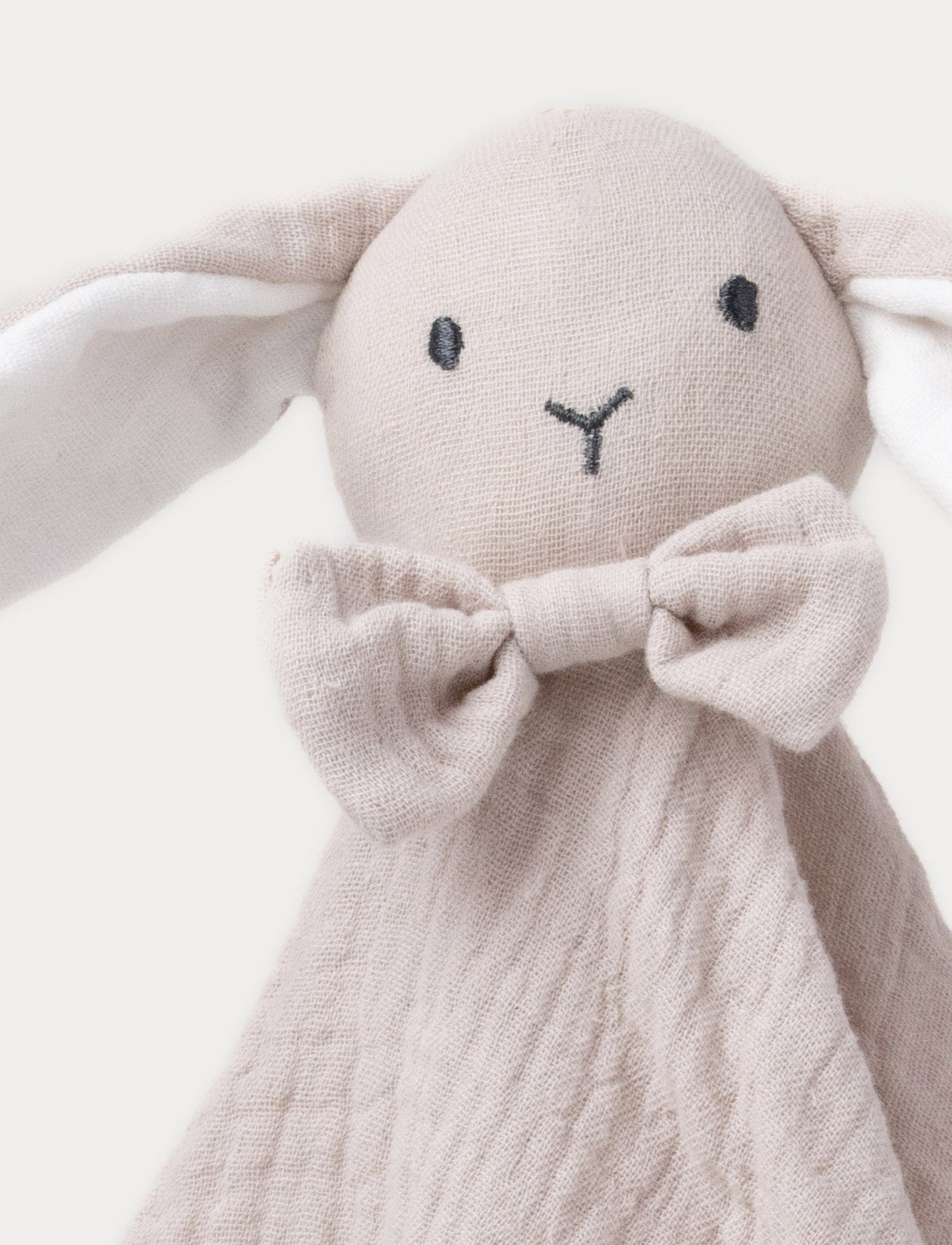 Soft baby blanket with a plush beige bunny head, long floppy ears, and a small bow.