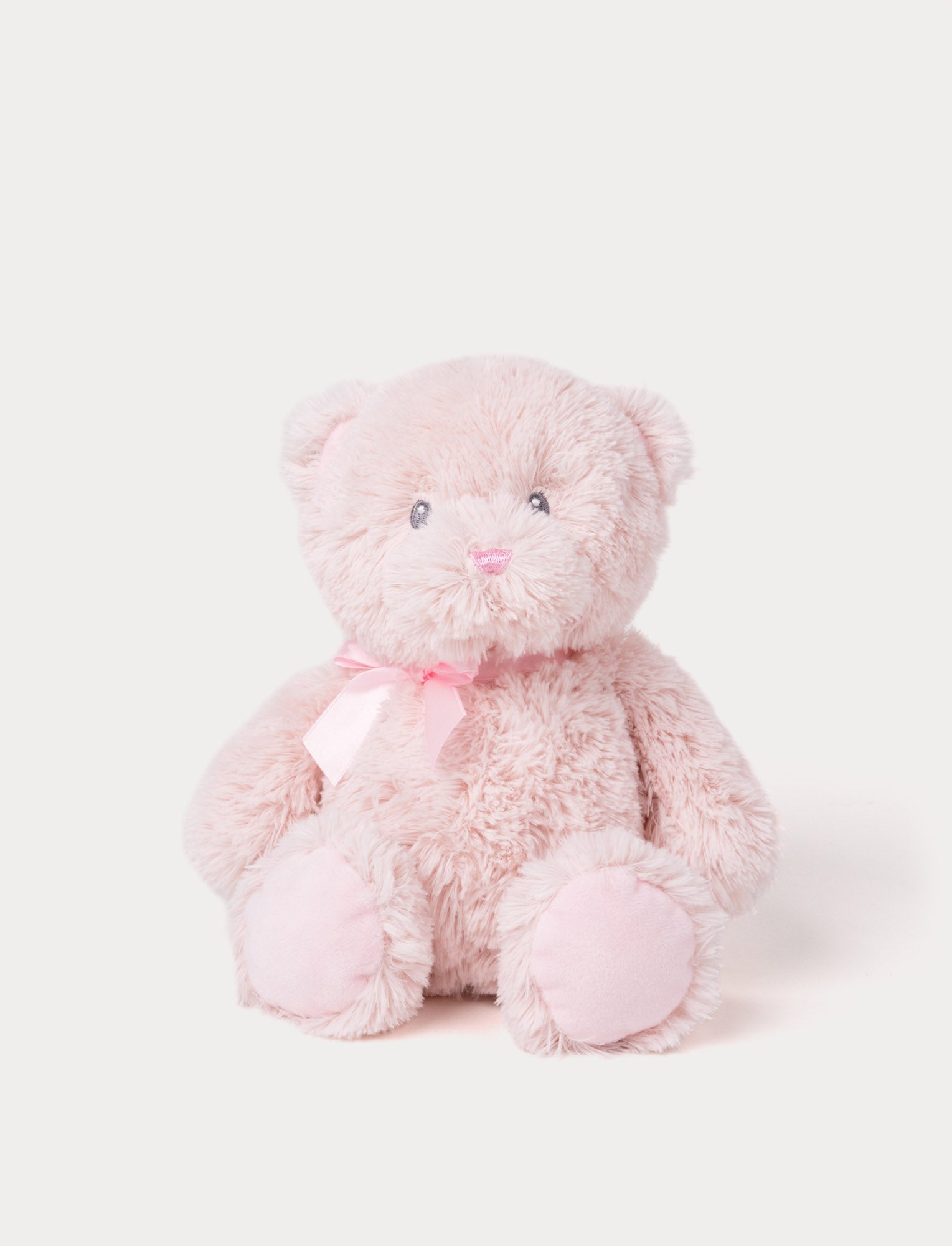  Image of Soft light pink teddy bear plush with a matching satin ribbon and embroidered facial features.