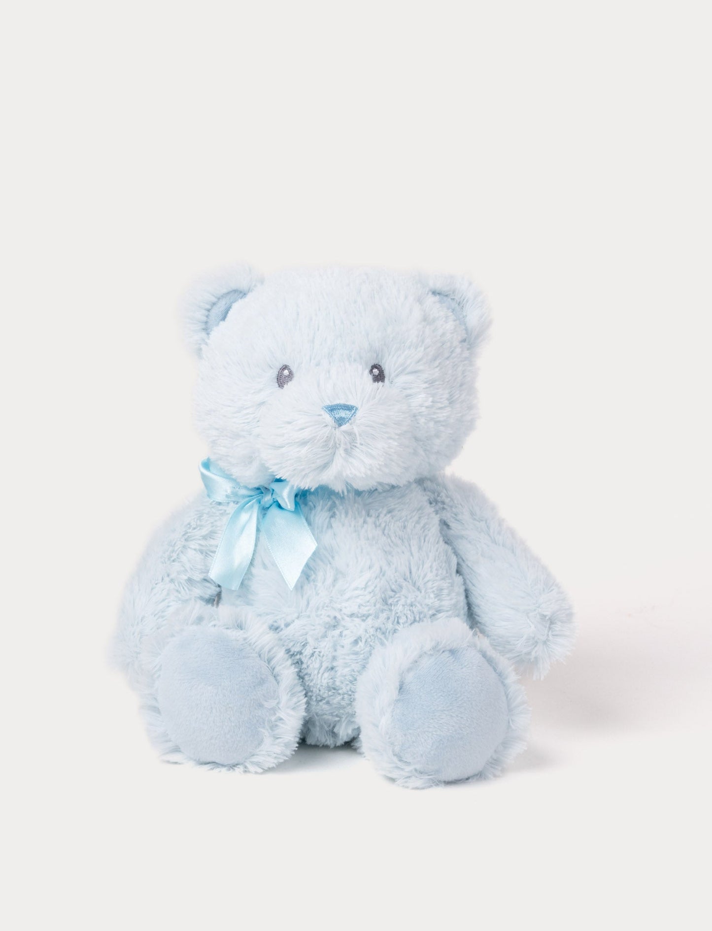 Soft light blue teddy bear plush with a matching satin ribbon and embroidered facial features.