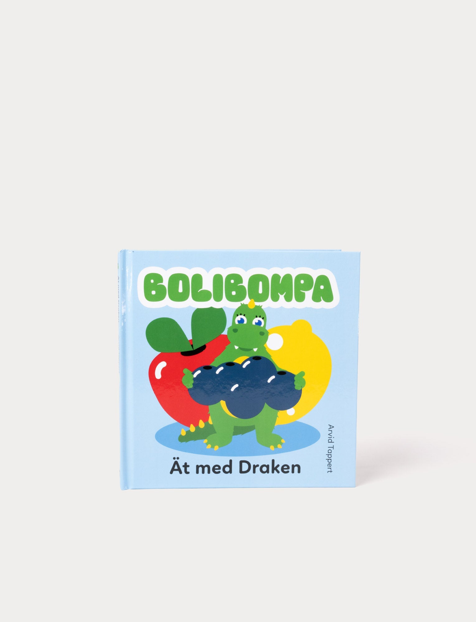  Image of Colorful picture book with Bolibompa Dragon, featuring vibrant illustrations of various foods and playful mealtime scenes.